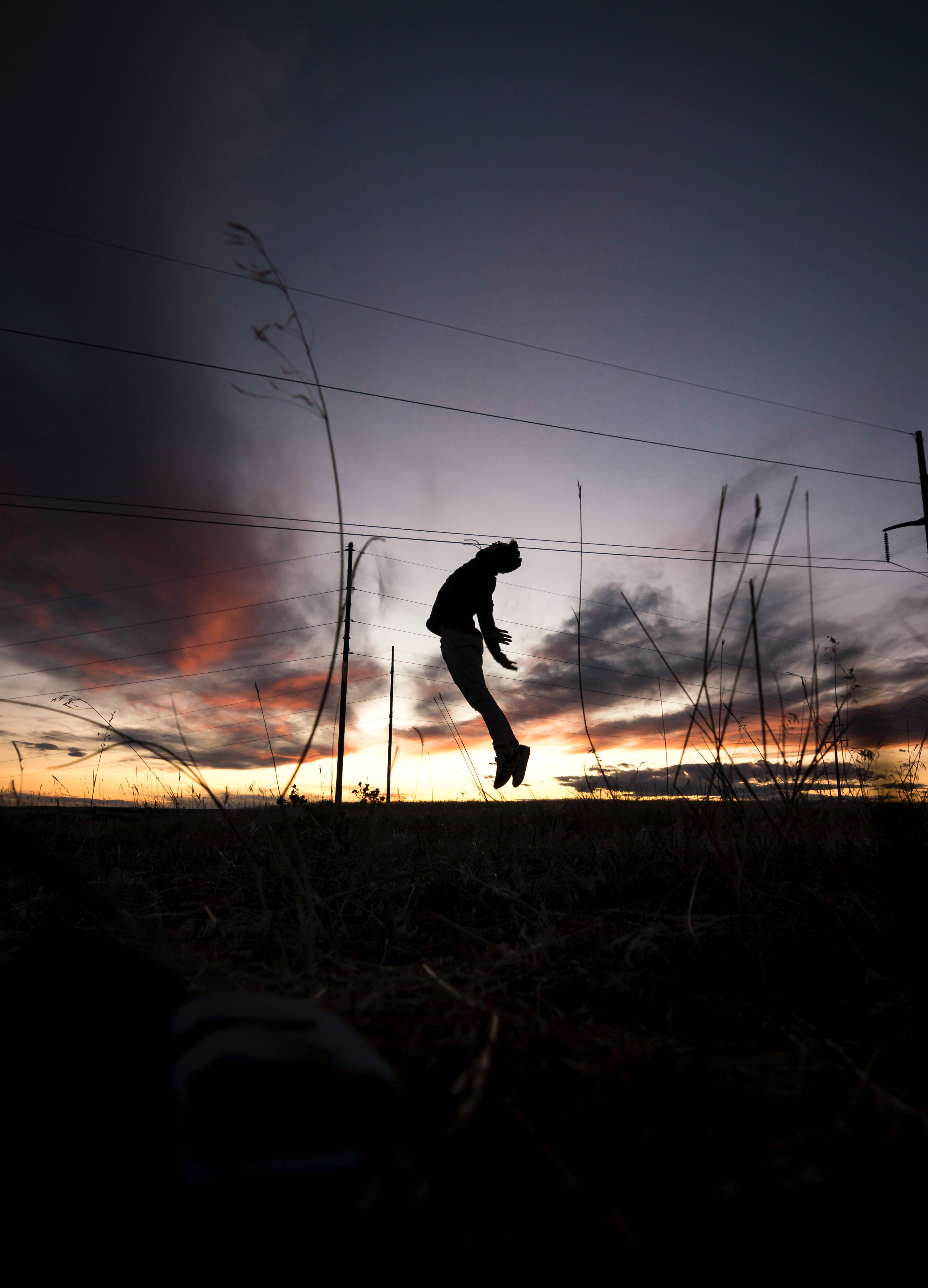 Free download wallpaper Sunset, Grass, Silhouette, Human, Person, Dark, Bounce, Jump on your PC desktop