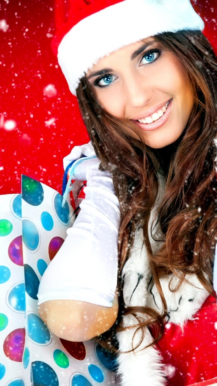 Download mobile wallpaper Christmas, Holiday, Smile, Snowflake, Brunette, Blue Eyes, Santa Hat for free.
