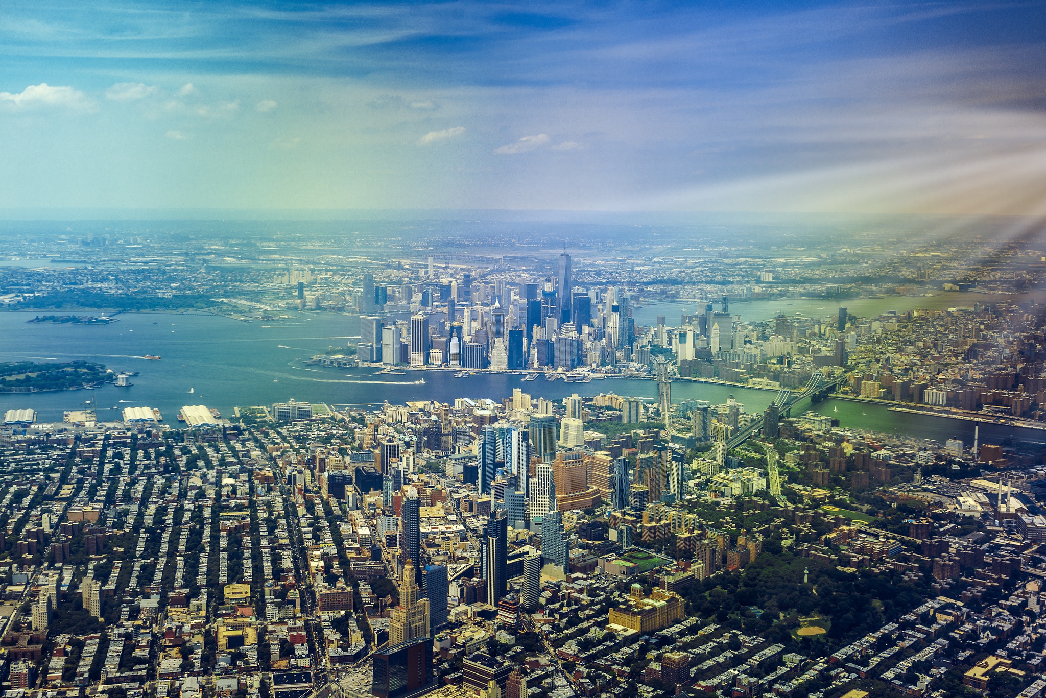 Download mobile wallpaper Cities, Usa, Skyscraper, Building, Horizon, Panorama, Cityscape, New York, Aerial, Sunbeam, Man Made for free.
