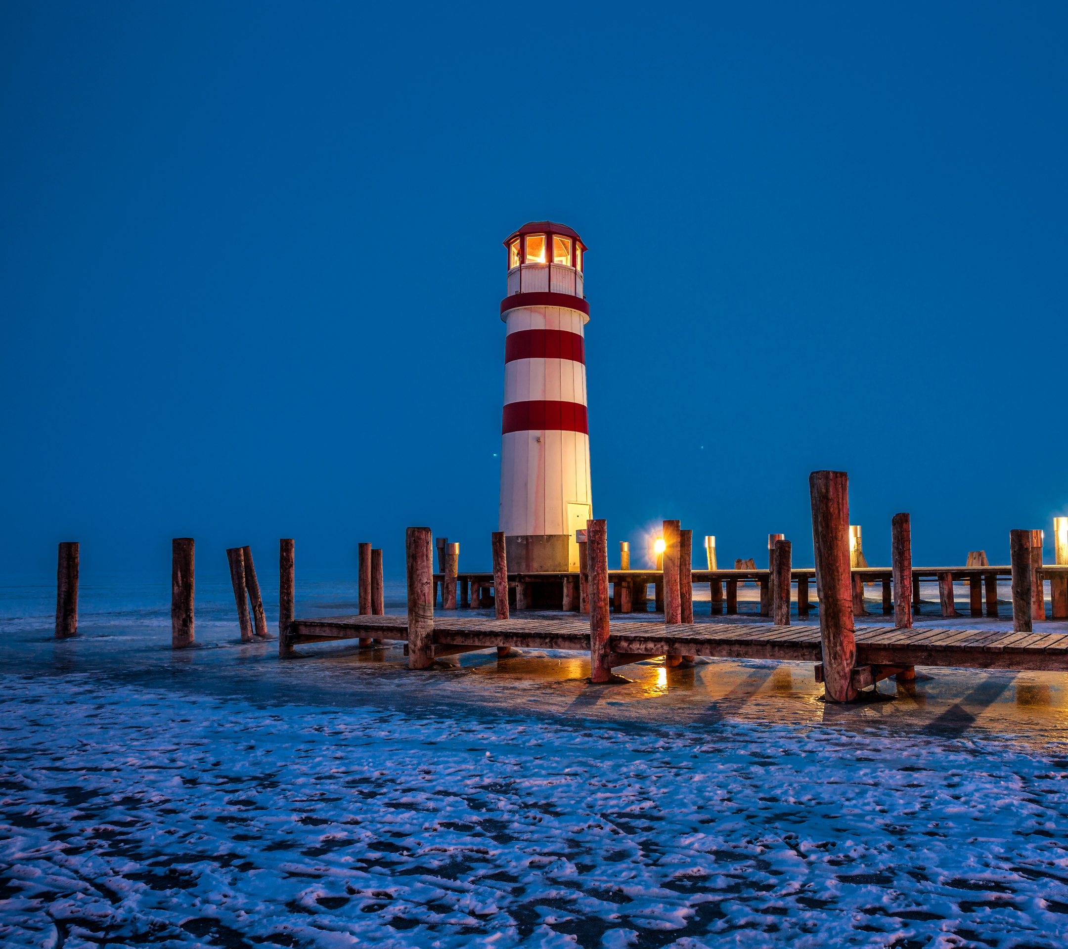 Download mobile wallpaper Winter, Ice, Night, Building, Pier, Lighthouse, Man Made for free.
