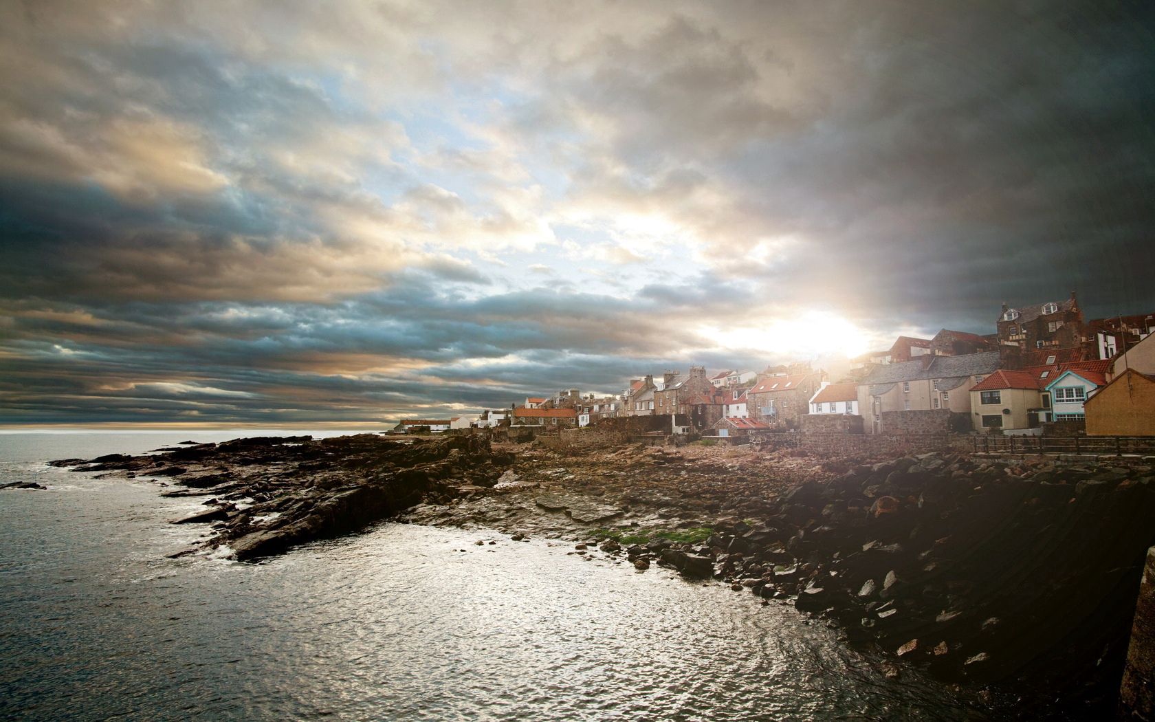 nature, houses, stones, sea, sun, clouds, city, shore, bank, shine, light, mainly cloudy, overcast