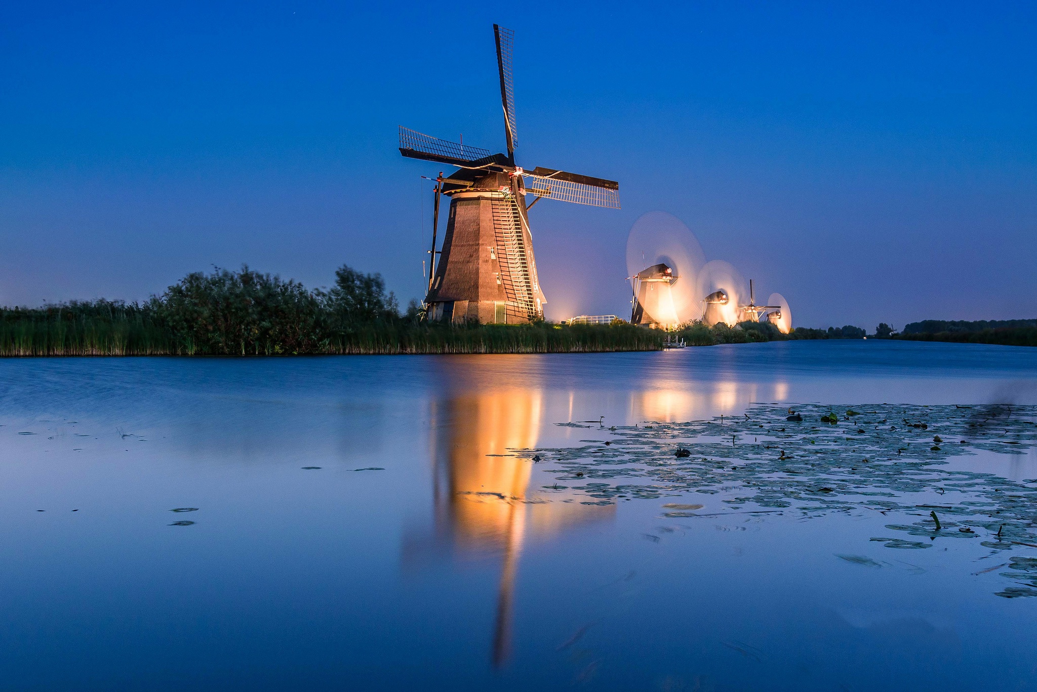 Free download wallpaper Night, Building, Reflection, River, Windmill, Man Made on your PC desktop