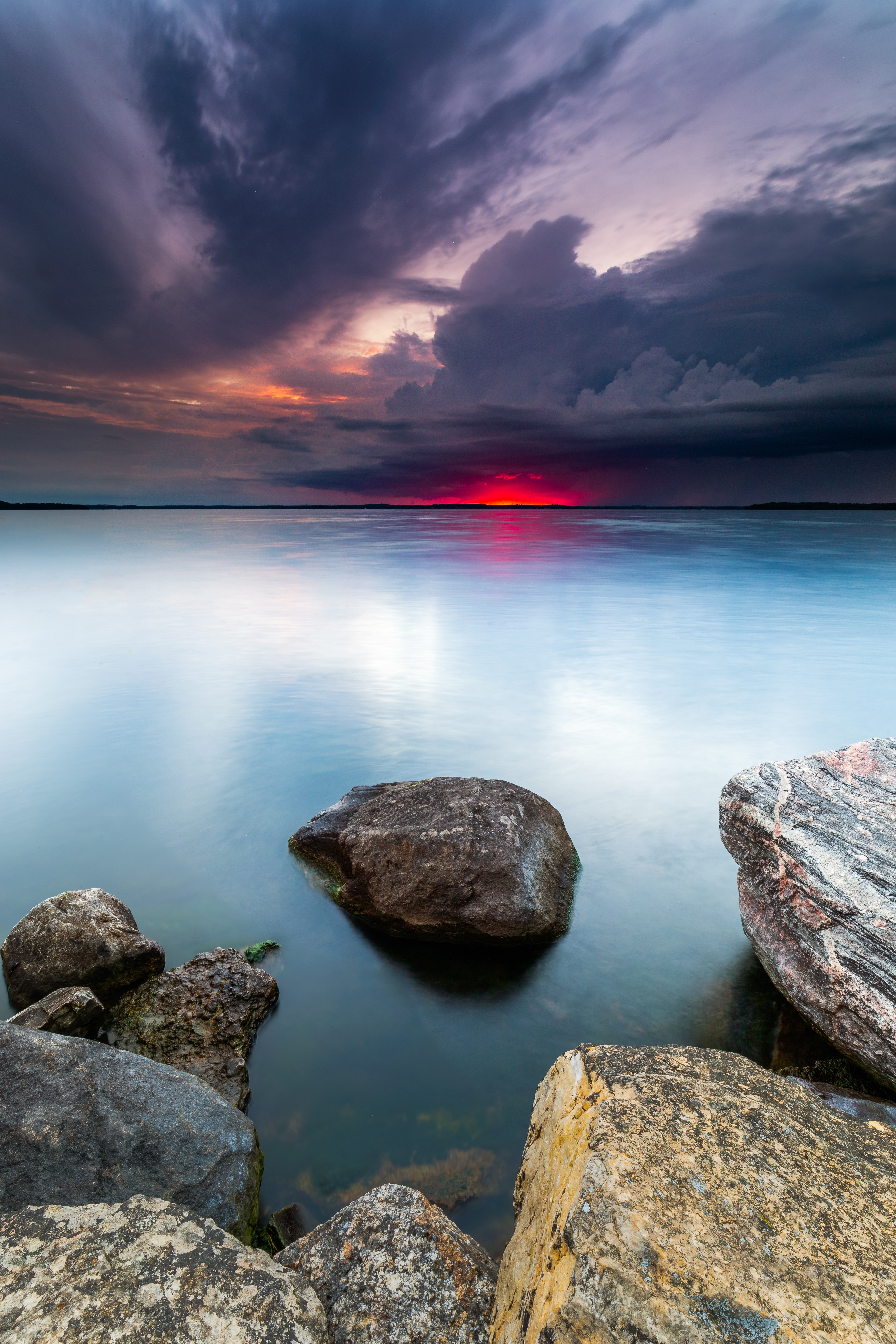 Download mobile wallpaper Horizon, Lake, Sunset, Stones, Water, Nature, Landscape for free.