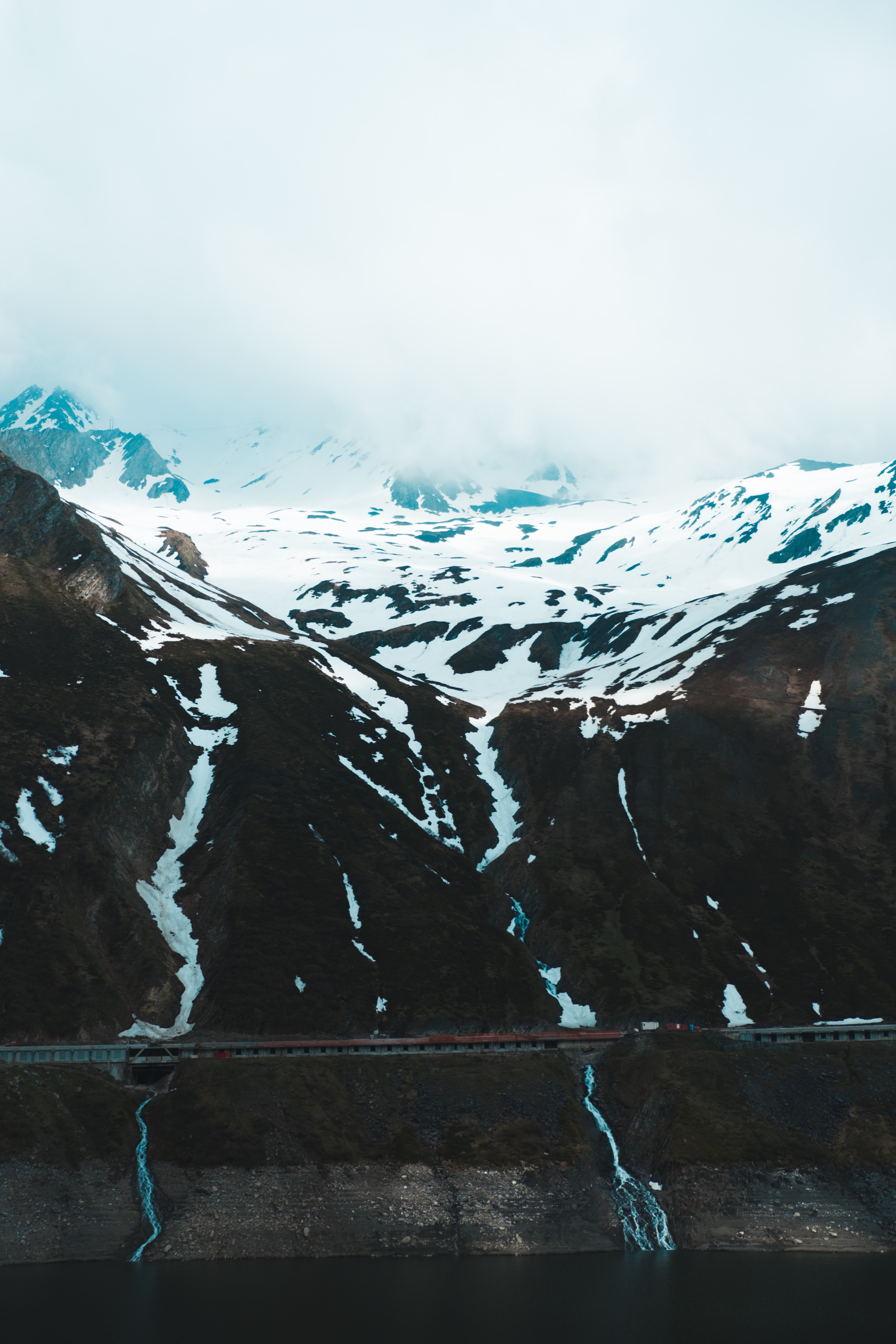 Download mobile wallpaper Slope, Precipice, Break, Clouds, Snow, Mountains, Nature for free.