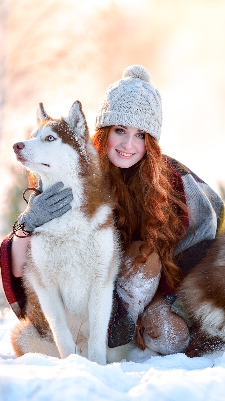 Download mobile wallpaper Winter, Snow, Dog, Smile, Redhead, Mood, Husky, Hat, Women for free.
