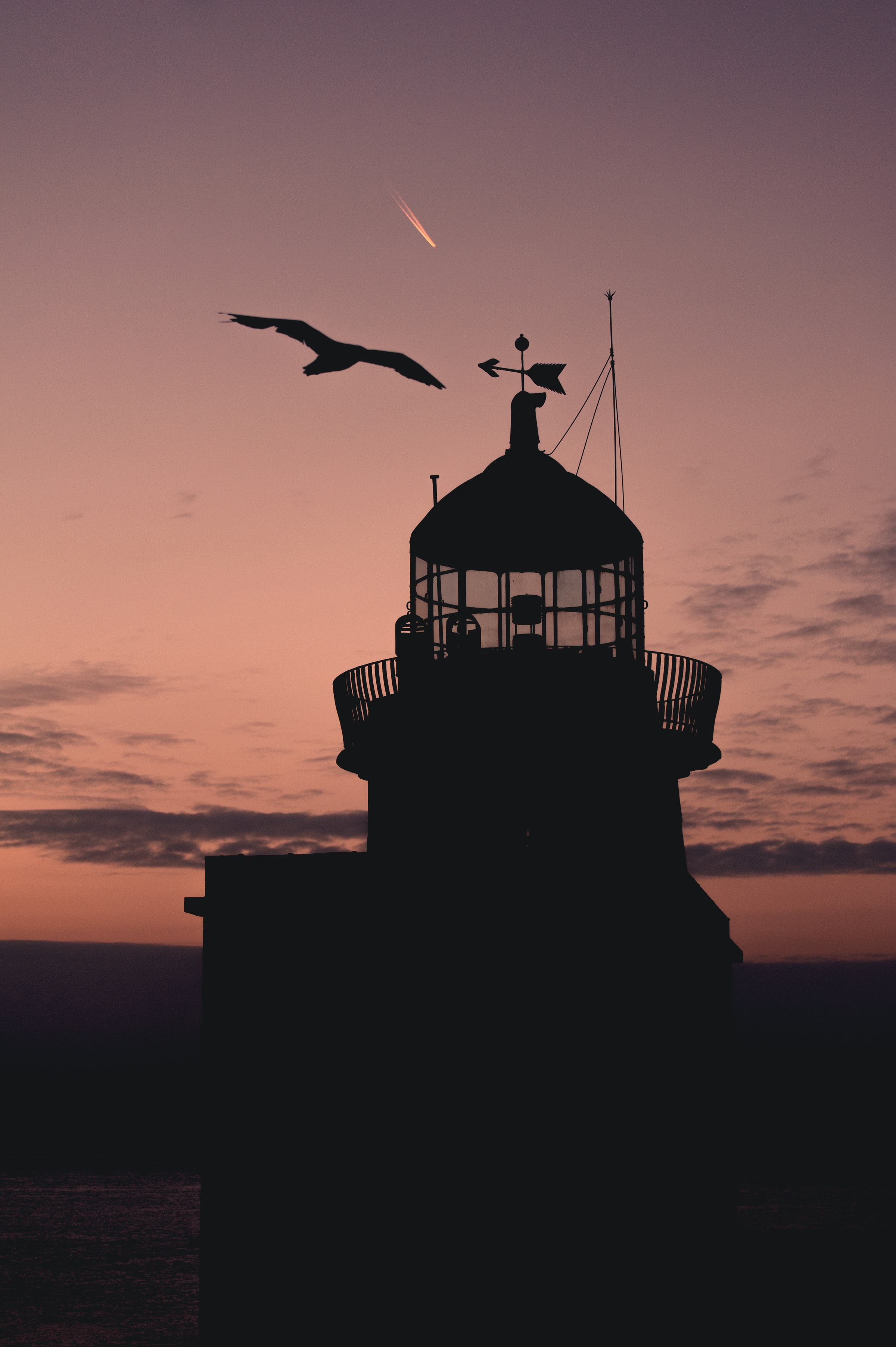 Download mobile wallpaper Building, Silhouette, Bird, Lighthouse, Sunset, Dark for free.