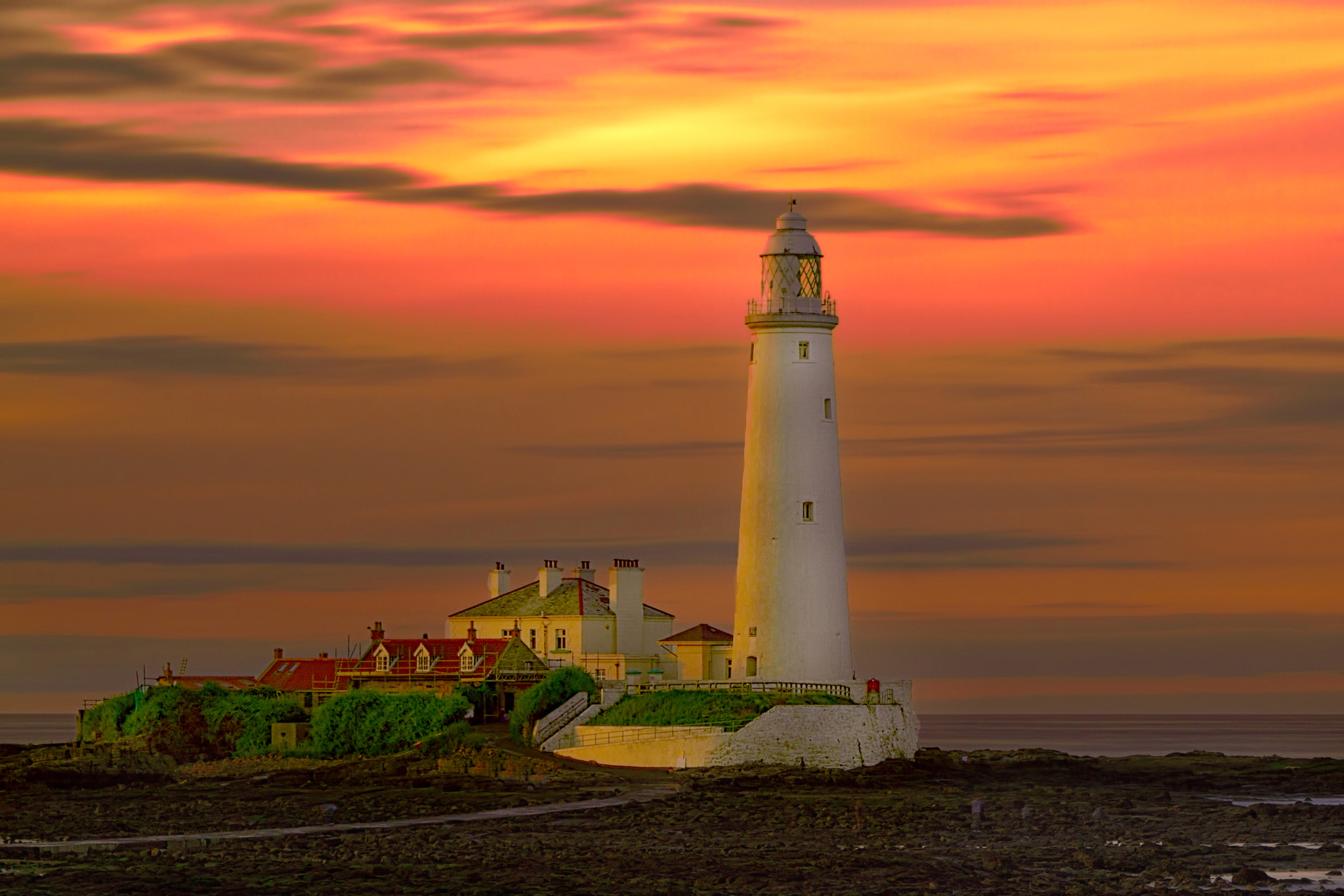 Download mobile wallpaper Sunset, Sky, Lighthouse, Man Made, Orange (Color) for free.
