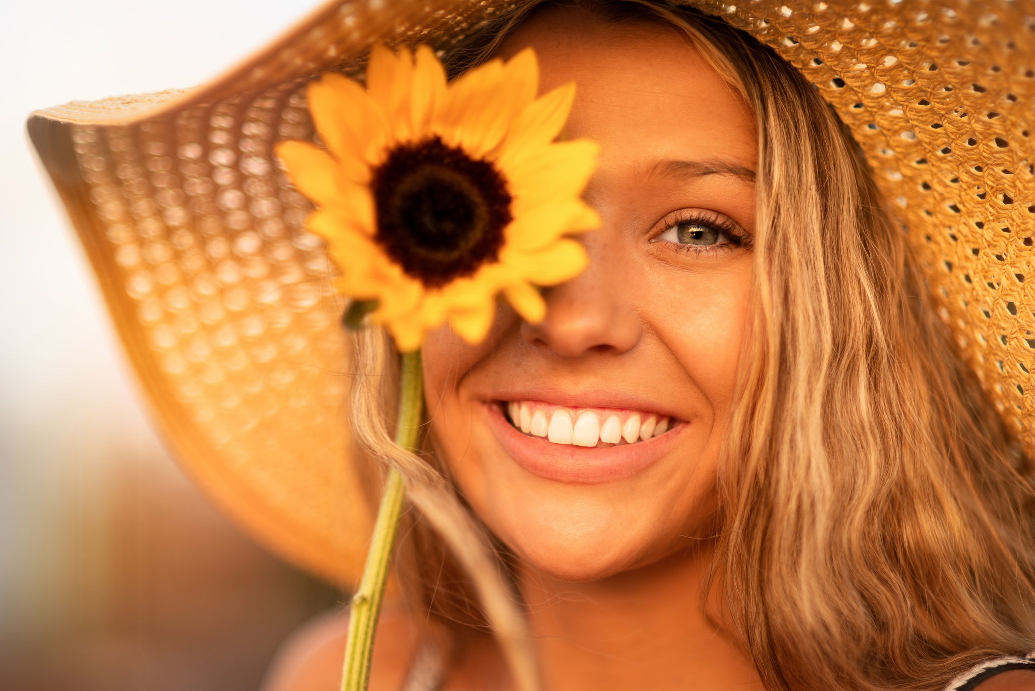 Download mobile wallpaper Smile, Blonde, Sunflower, Face, Hat, Model, Women for free.