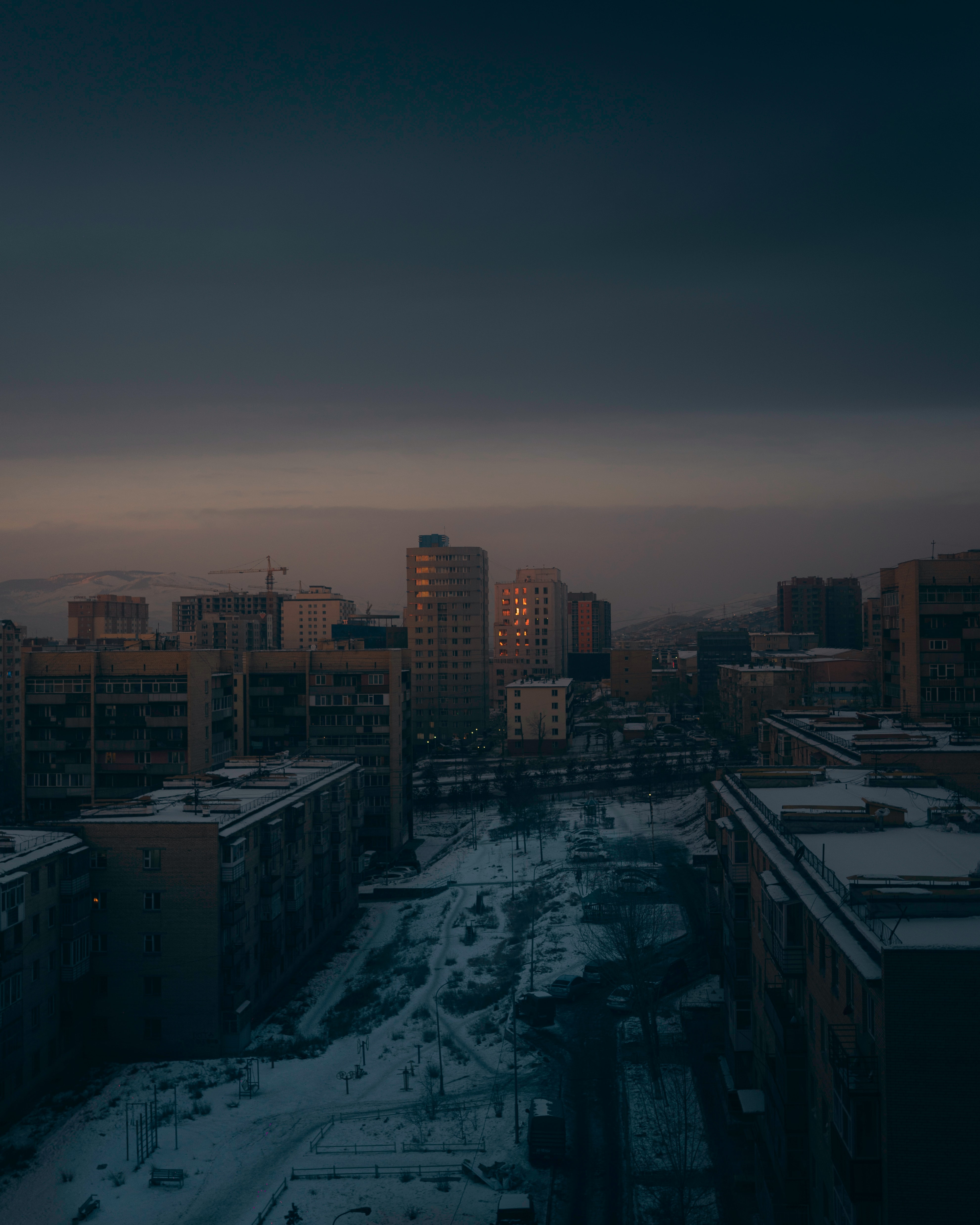 Download mobile wallpaper Winter, Building, City, Cities, Dusk, Snow, View From Above, Twilight for free.
