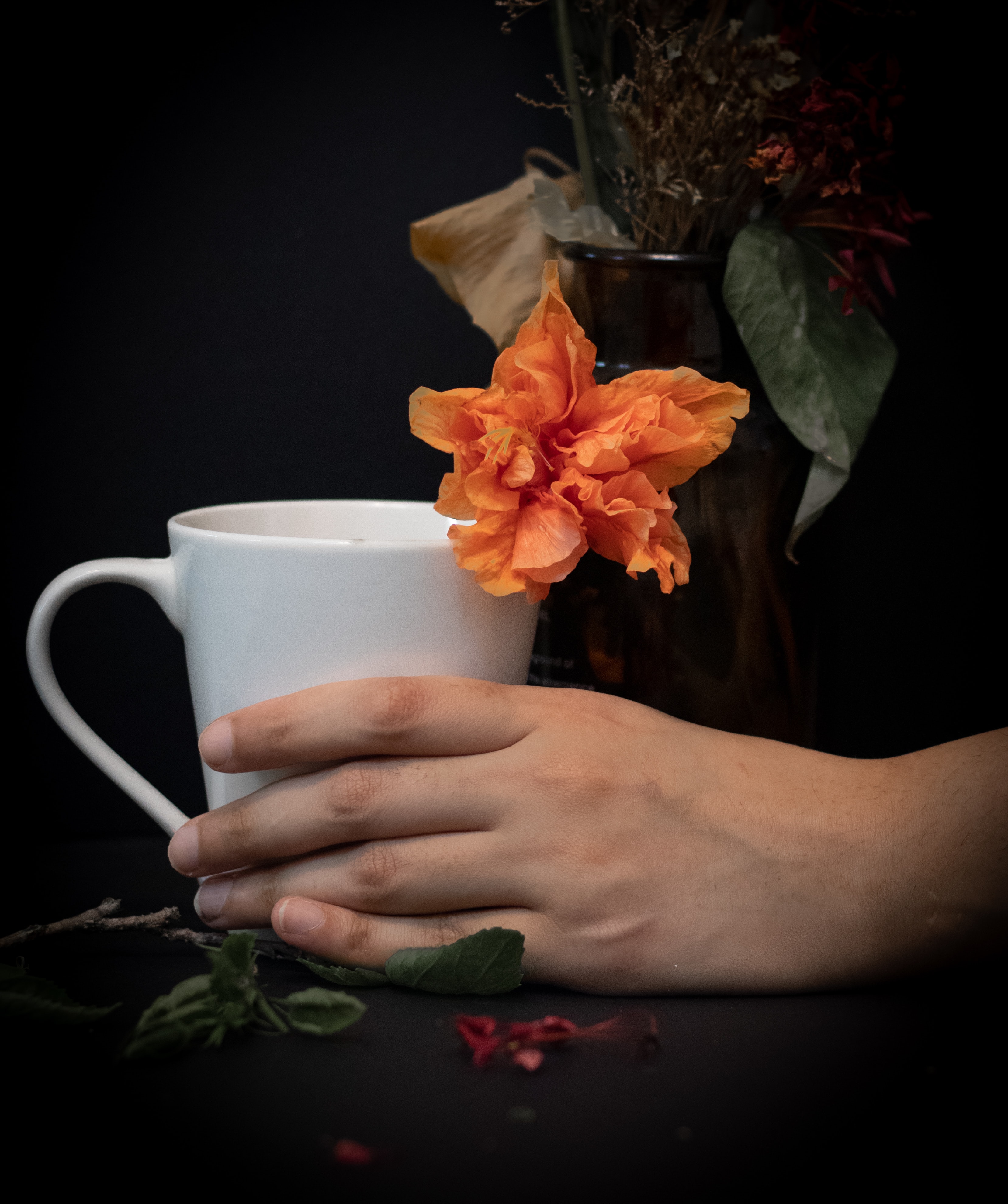 Download mobile wallpaper Miscellaneous, Miscellanea, Cup, Hand, Flowers, Dark for free.