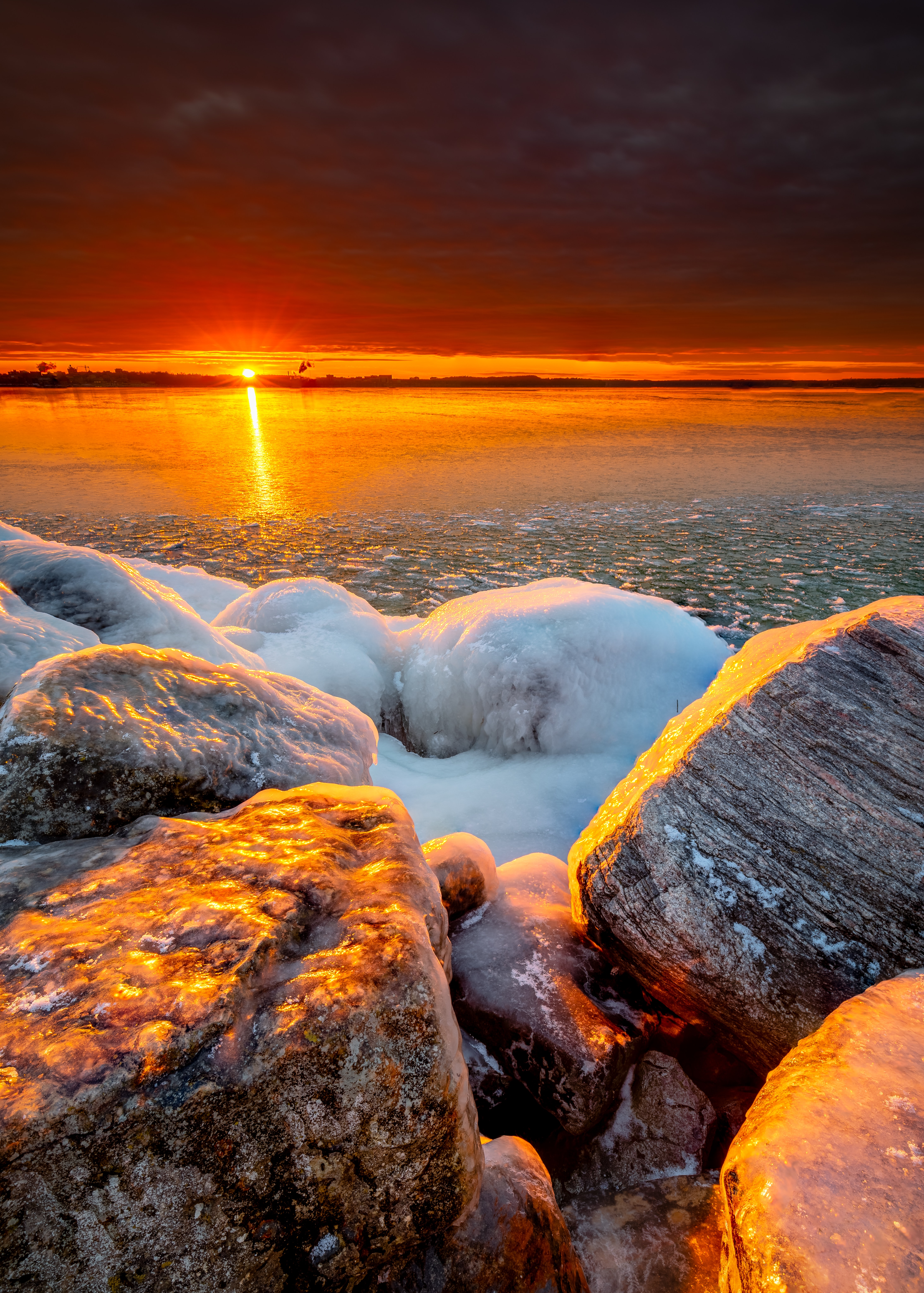 Download mobile wallpaper Shore, Bank, Stones, Ice, Nature, Sunset, Sea for free.
