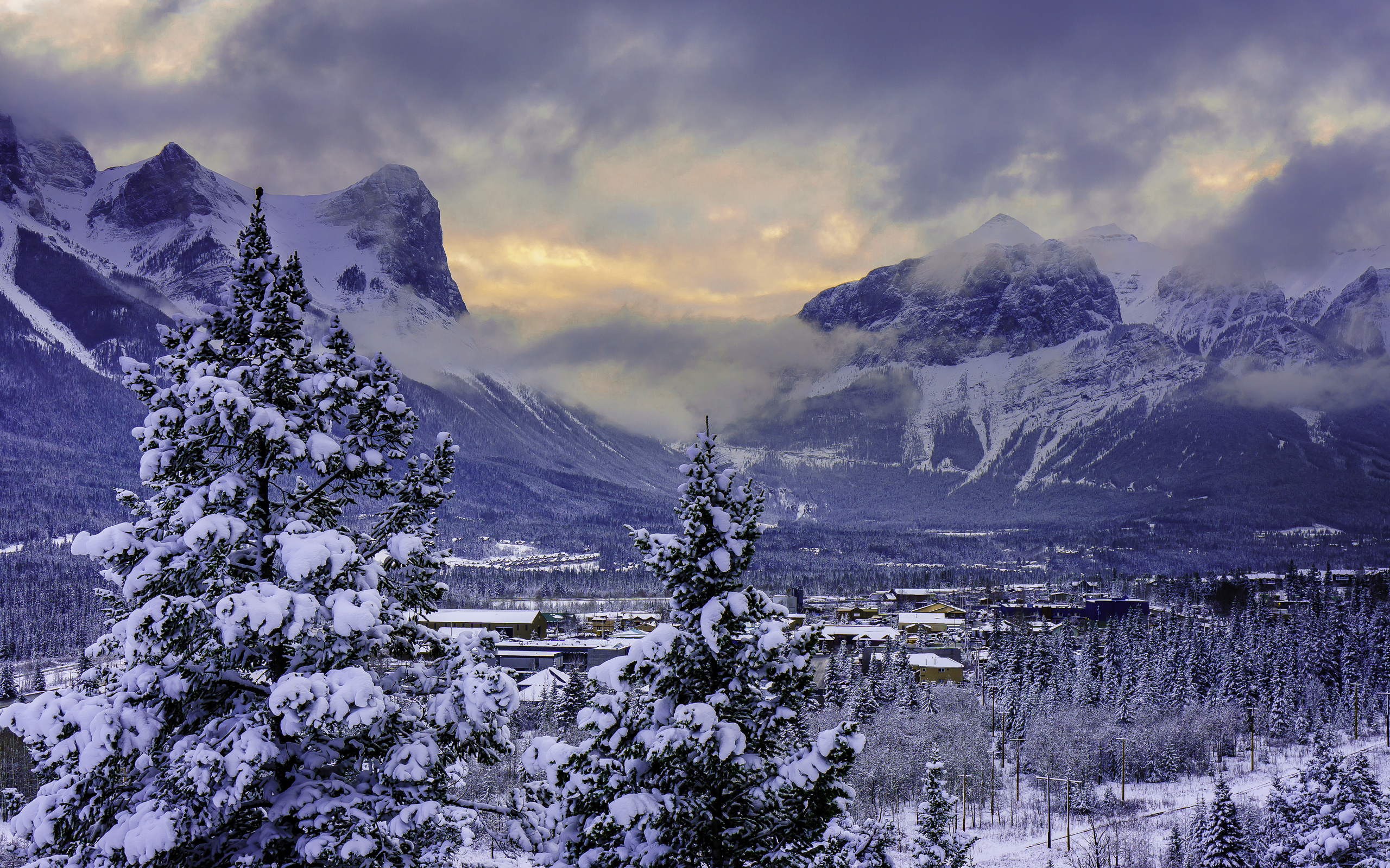 Download mobile wallpaper Snow, Village, Mountains, Canada, Winter, Tree, Mountain, Earth, Landscape for free.