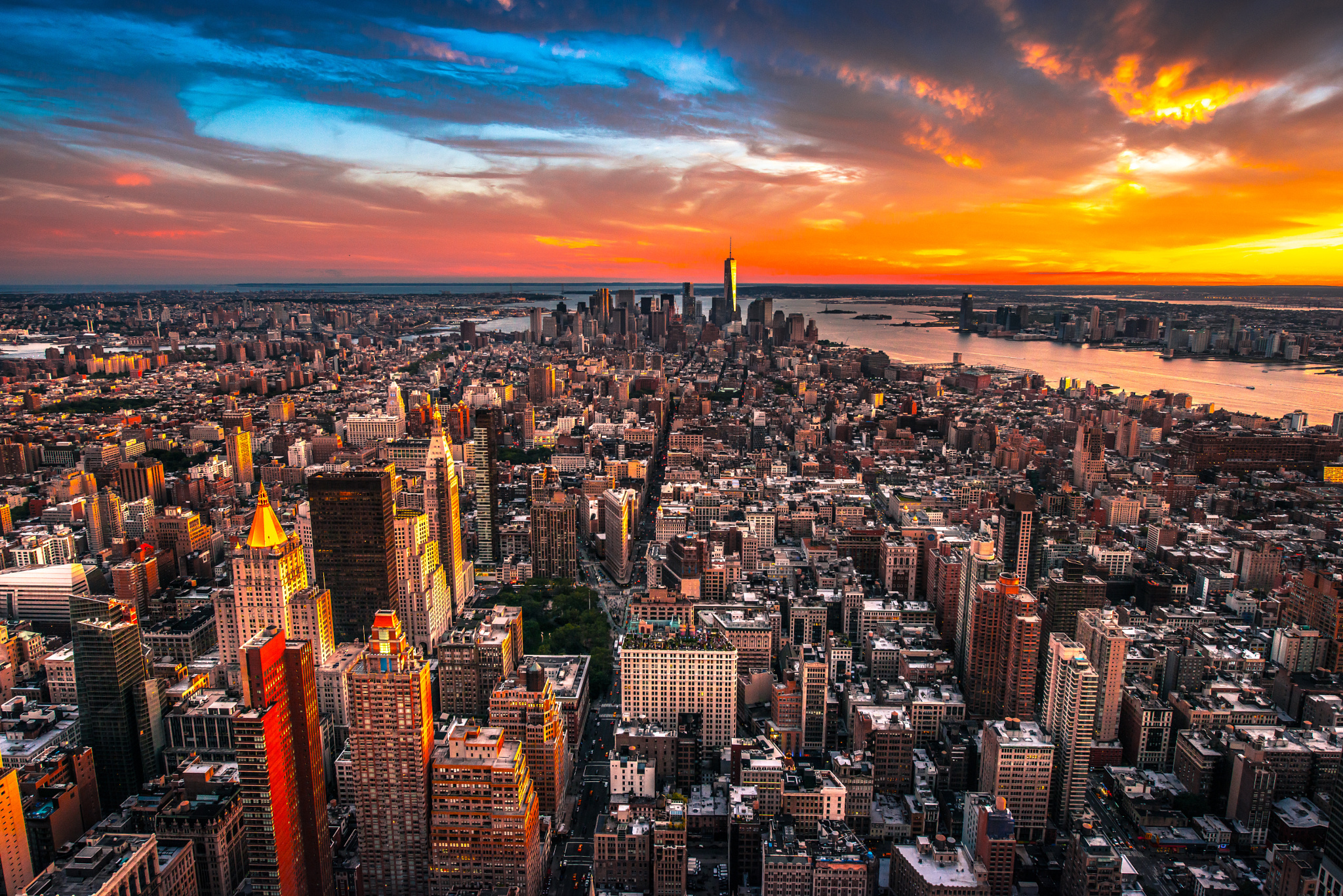 Download mobile wallpaper Cities, Sunset, Sky, Usa, City, Skyscraper, Building, Horizon, Cityscape, Cloud, New York, Aerial, Man Made for free.