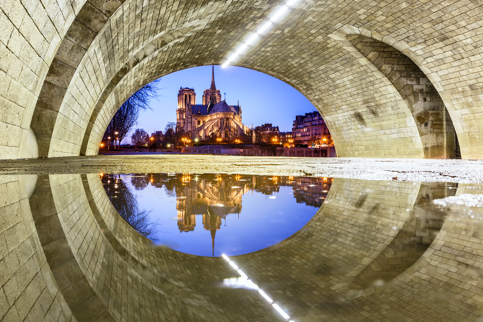 Download mobile wallpaper Water, Night, Paris, Reflection, France, Tunnel, Cathedral, Notre Dame De Paris, Religious, Cathedrals for free.