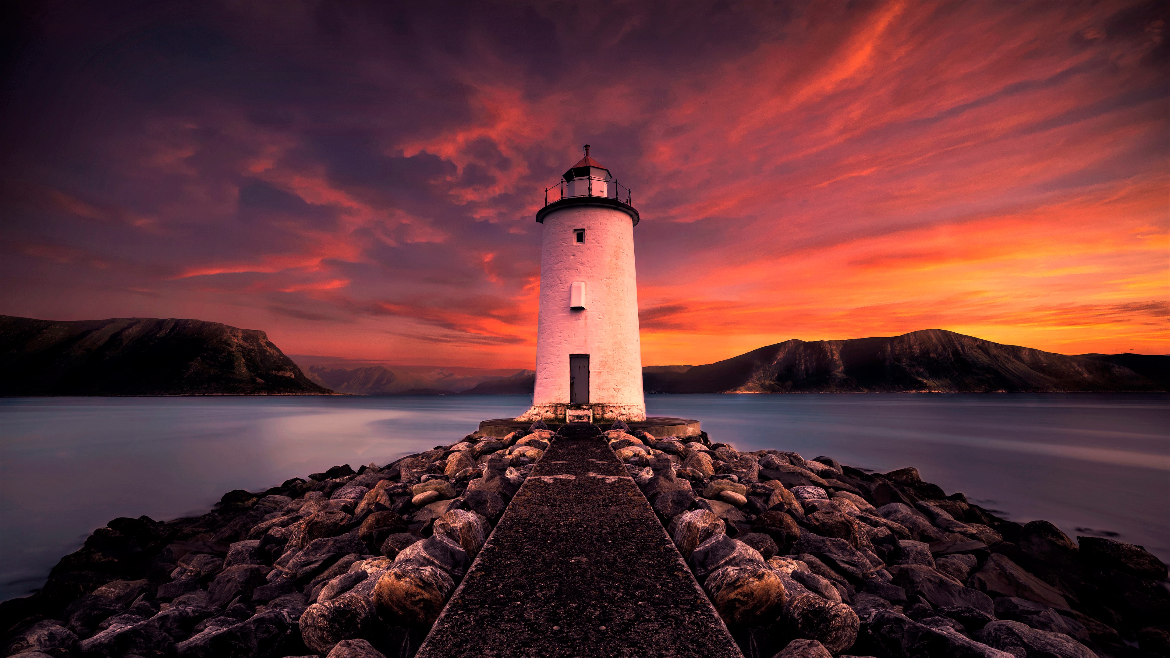 Download mobile wallpaper Sunset, Sea, Building, Mountain, Lighthouse, Man Made for free.
