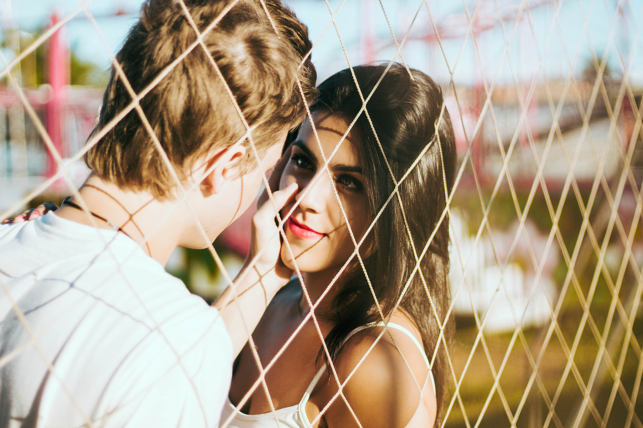 Free download wallpaper Love, Couple, Fence, Brunette, Photography, Depth Of Field on your PC desktop