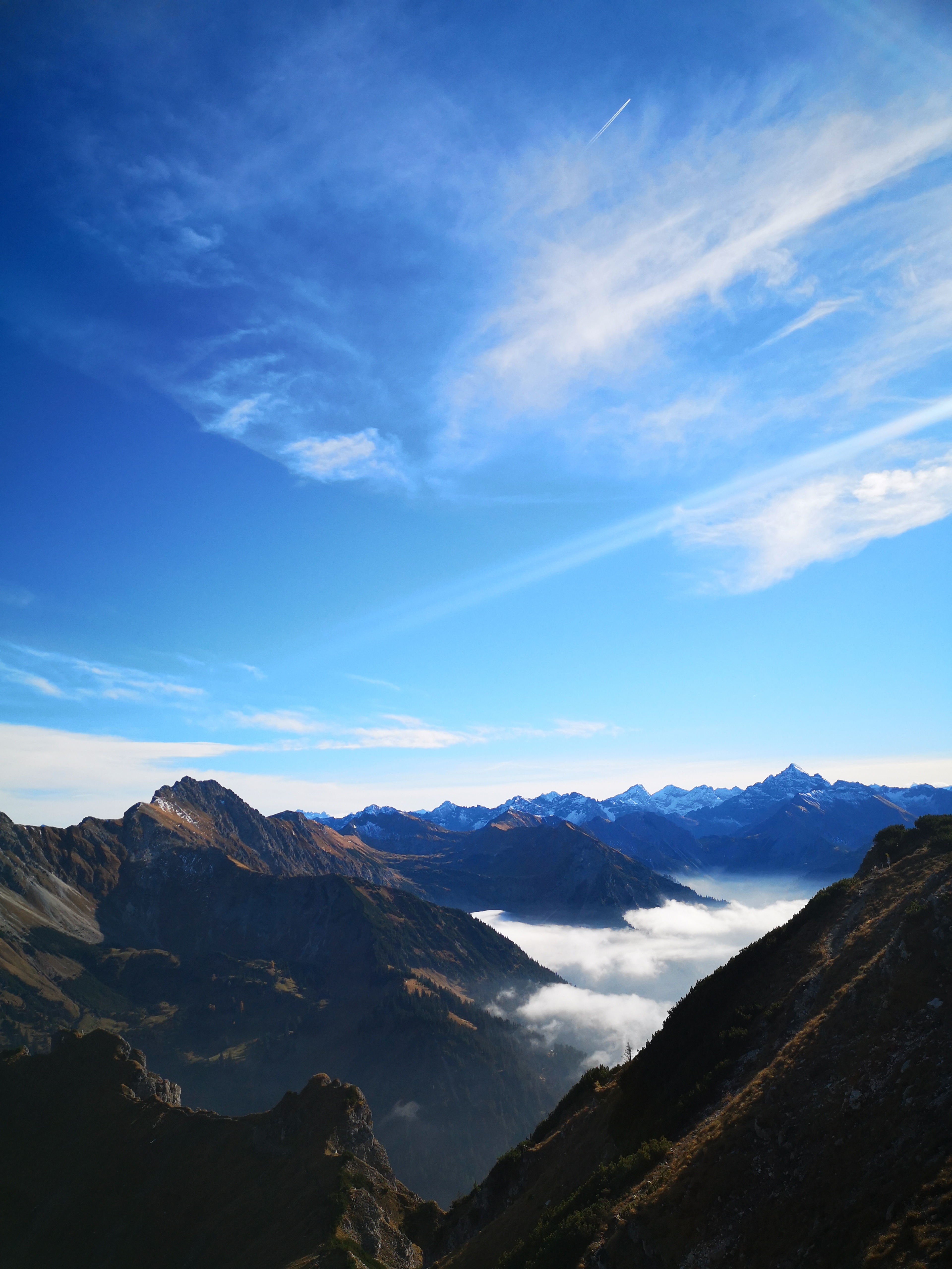 Download mobile wallpaper Tops, Vertex, Clouds, Nature, Alps, Fog, Mountains, View From Above for free.
