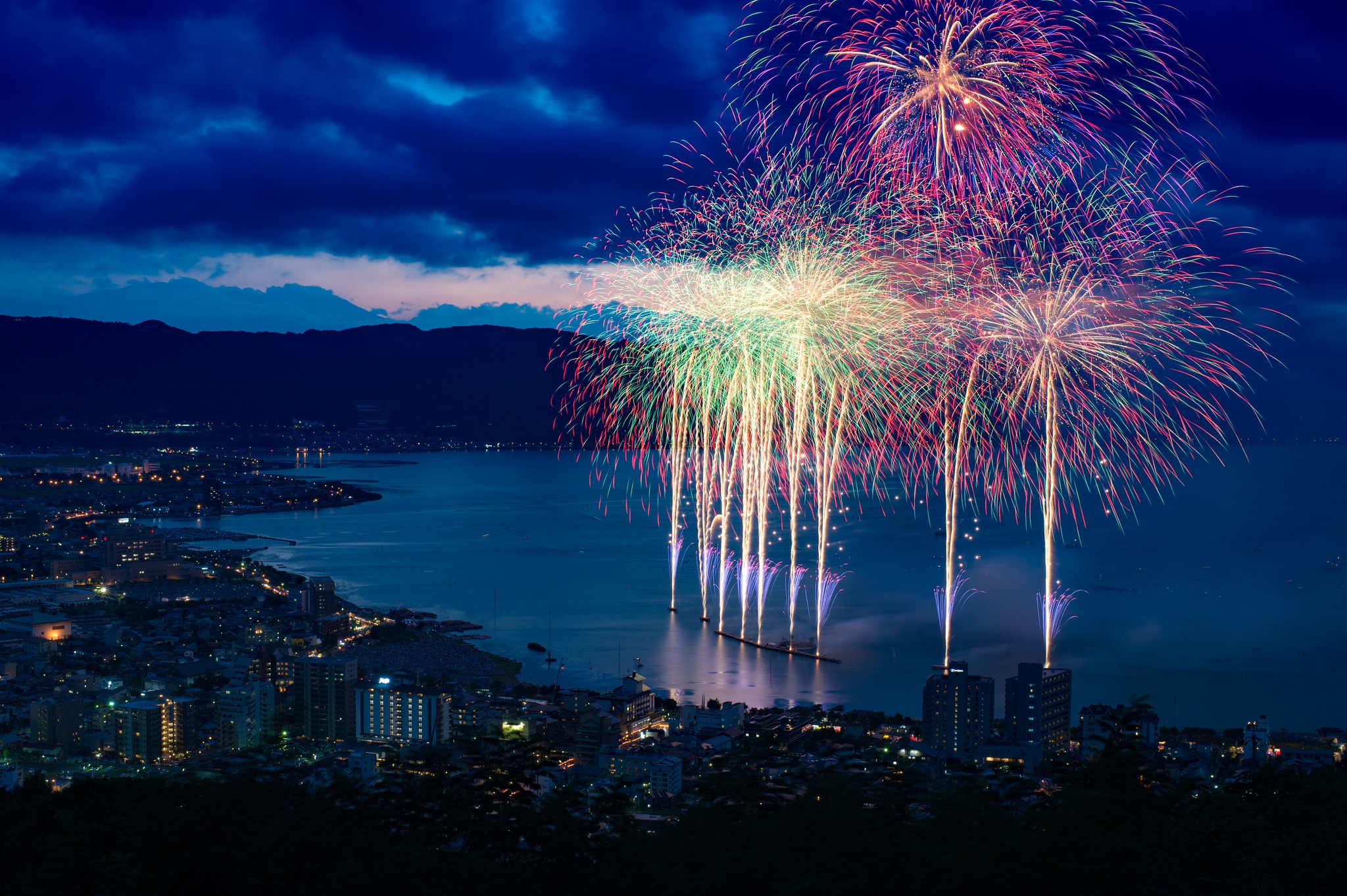 Download mobile wallpaper Night, City, Japan, Fireworks, Coastline, Photography for free.