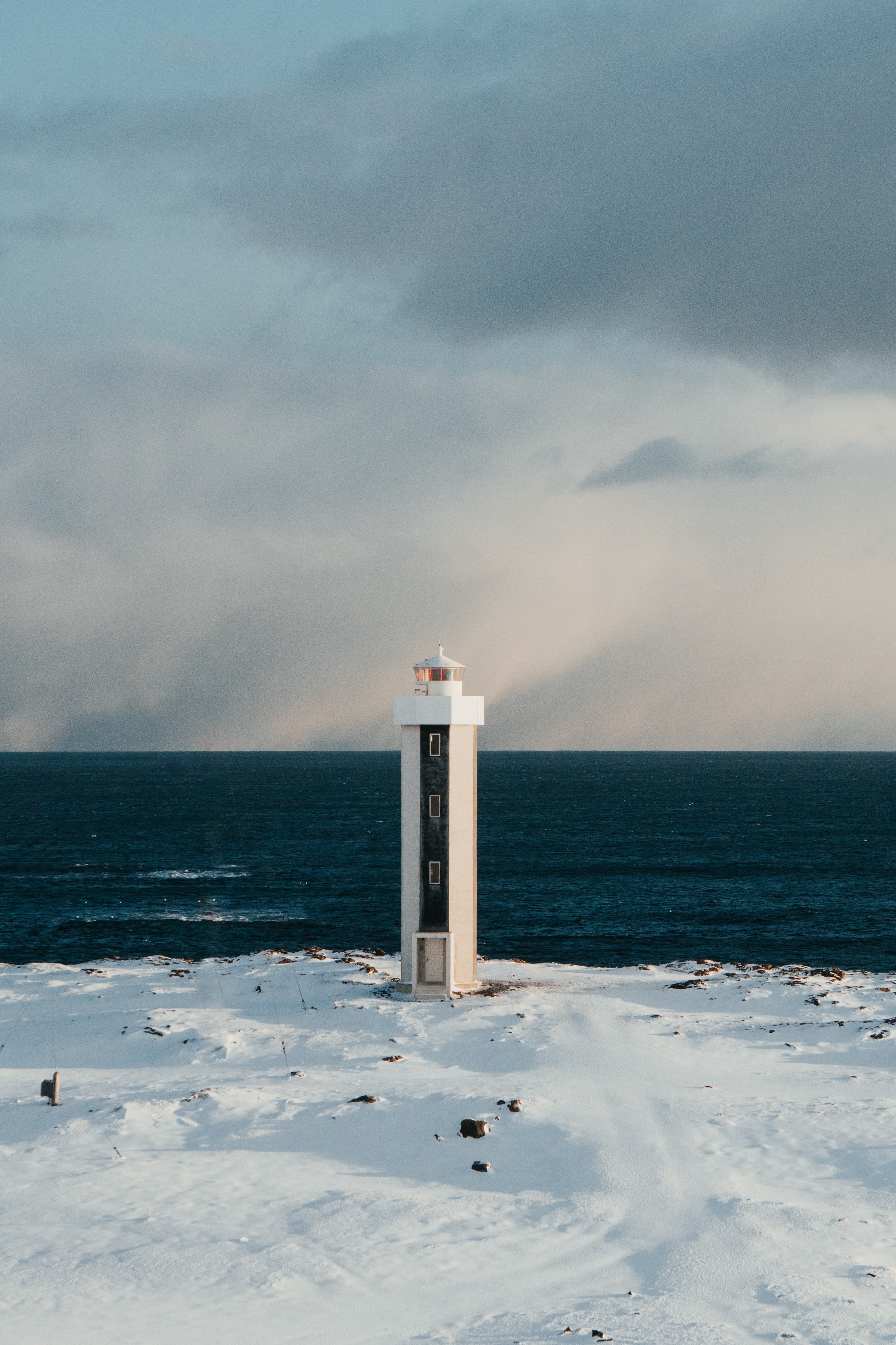 Download mobile wallpaper Snow, Building, Horizon, Nature, Lighthouse for free.