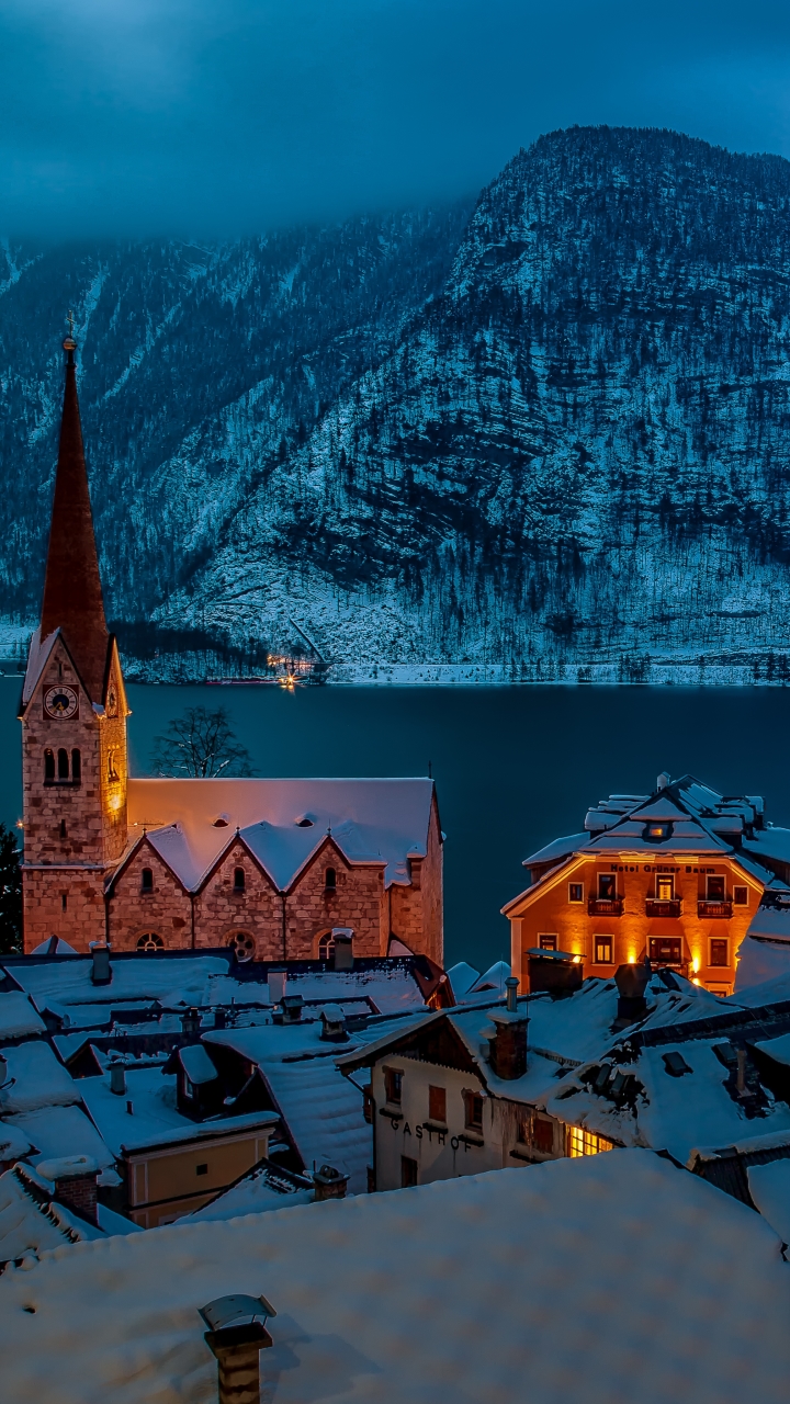 Download mobile wallpaper Winter, Night, Snow, Mountain, House, Town, Hallstatt, Man Made, Towns for free.