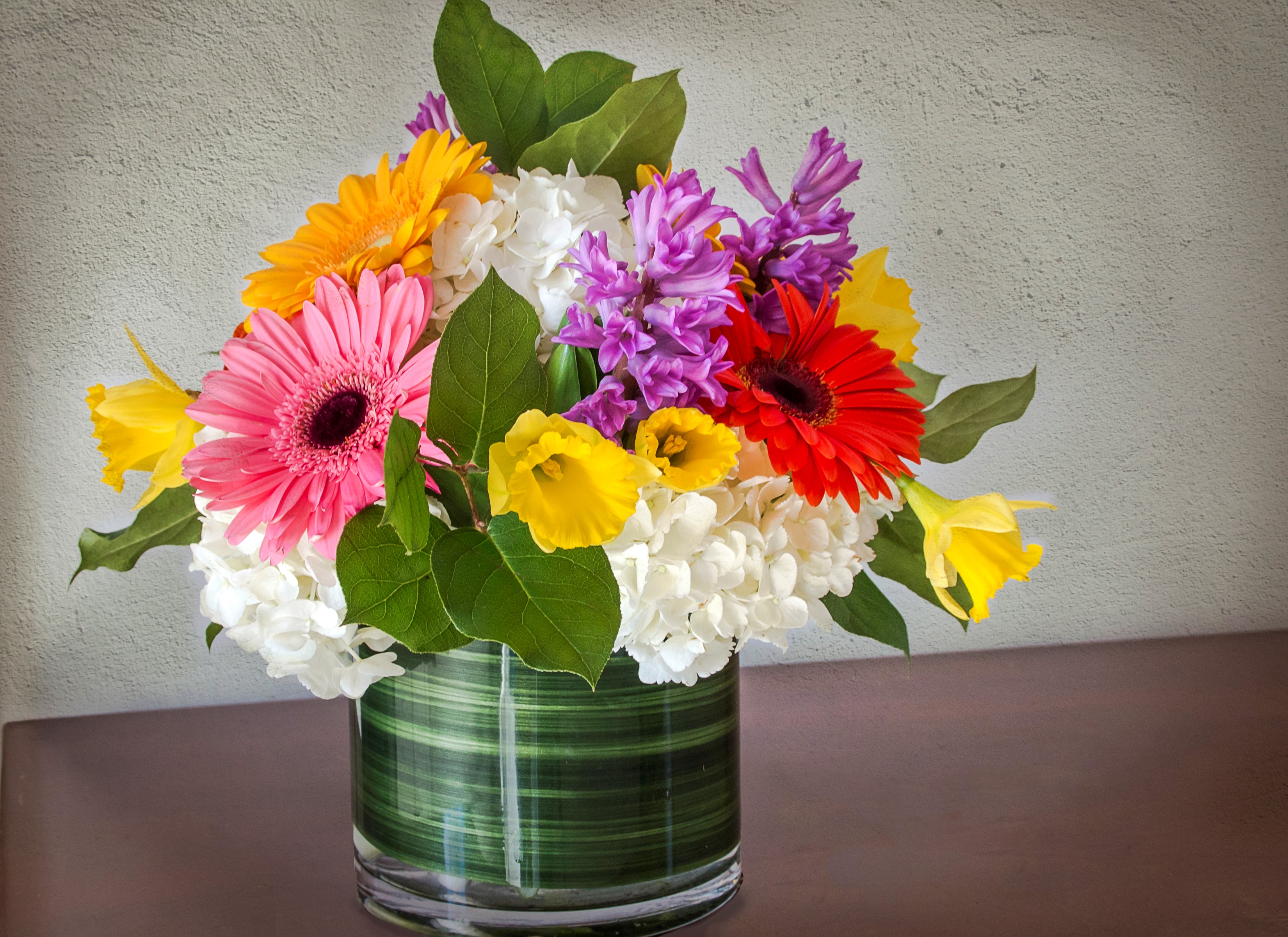 Download mobile wallpaper Flower, Earth, Vase, Colorful, Gerbera, Man Made for free.