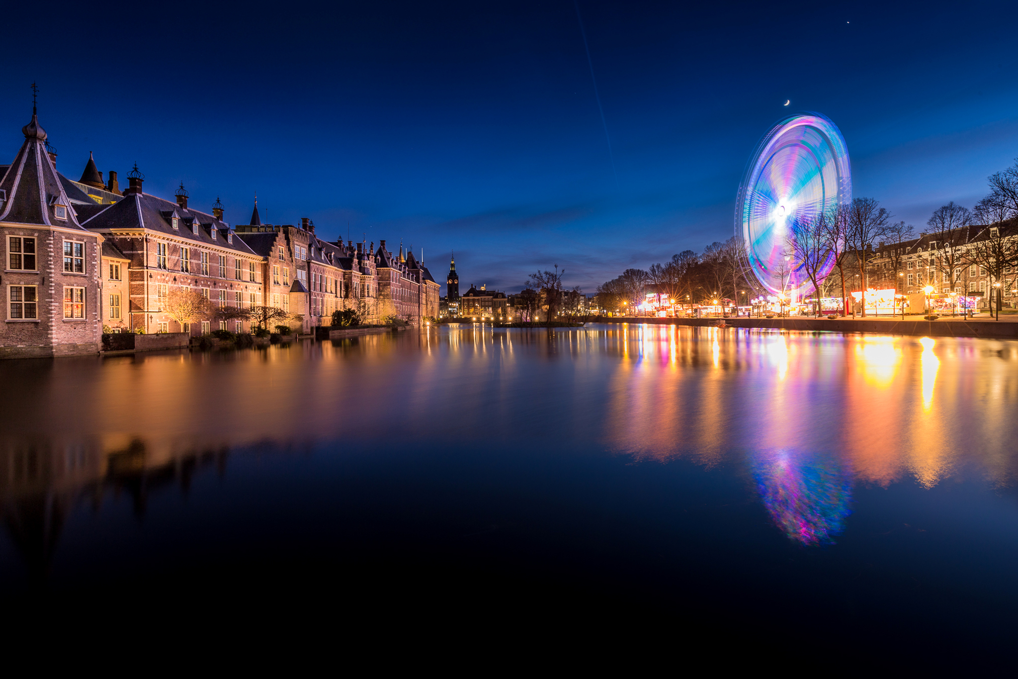 Download mobile wallpaper Cities, Night, City, Reflection, Light, Ferris Wheel, River, Netherlands, Man Made, The Hague for free.