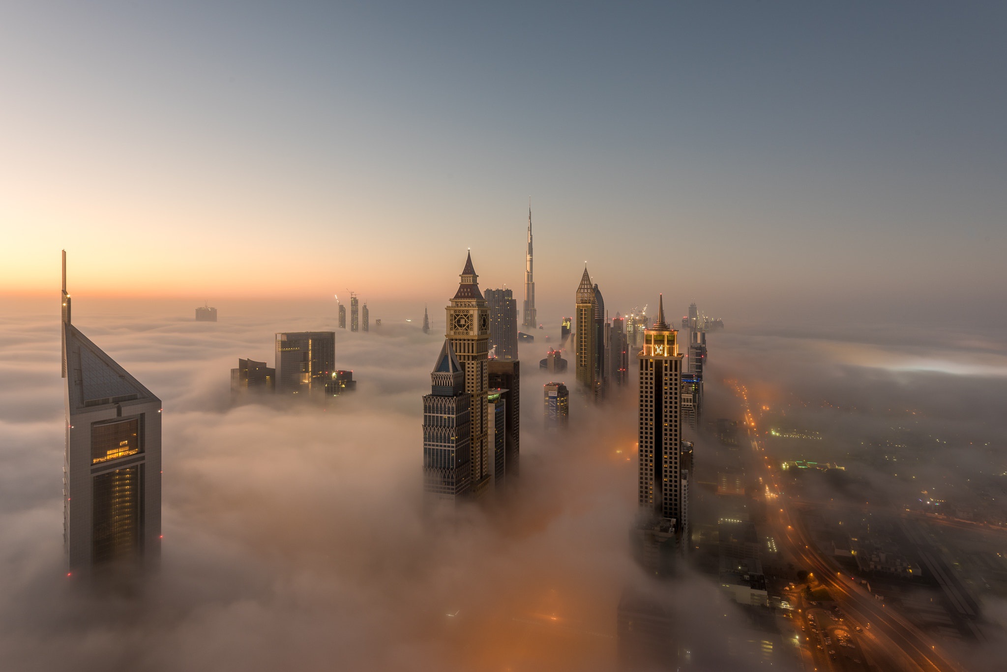 Download mobile wallpaper Cities, Skyscraper, Fog, Dubai, Cityscape, United Arab Emirates, Aerial, Man Made for free.