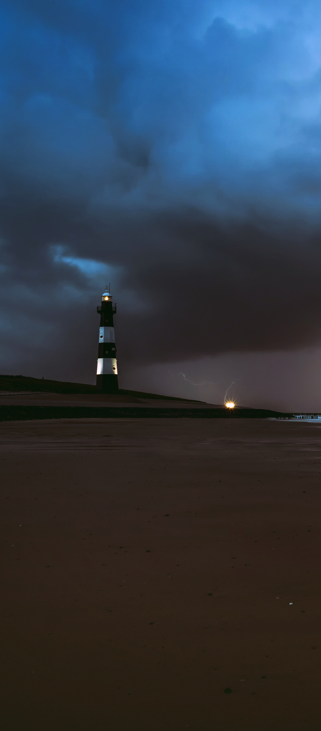 Download mobile wallpaper Night, Beach, Sand, Lighthouse, Man Made for free.