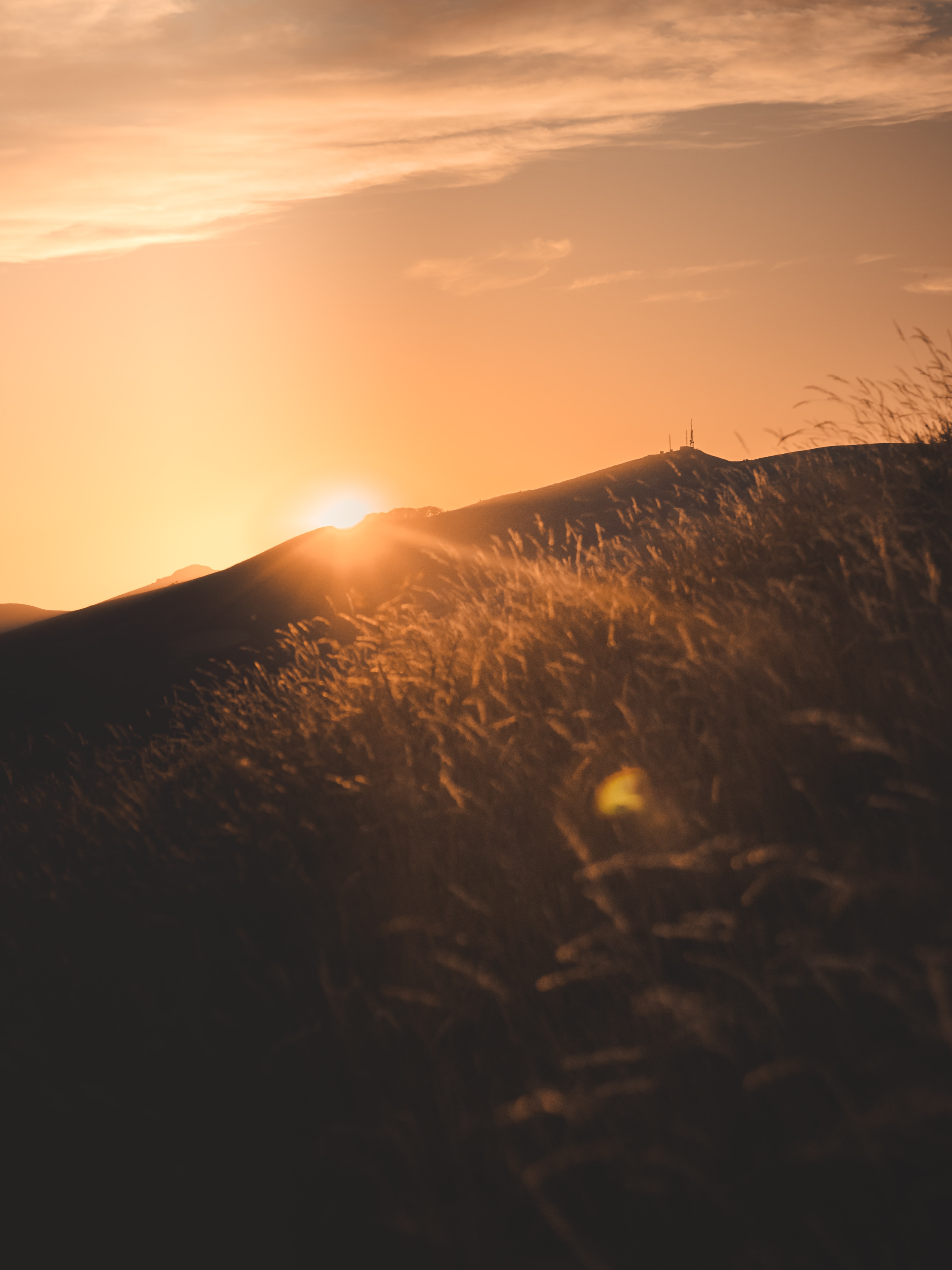 Download mobile wallpaper Beams, Slope, Rays, Hill, Nature, Sunset, Sun for free.