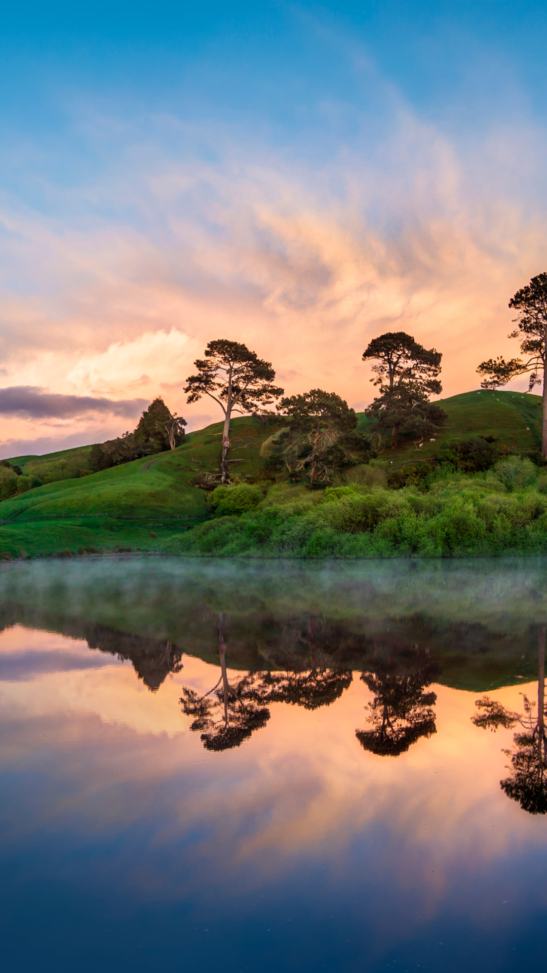Download mobile wallpaper Sky, Lake, Reflection, New Zealand, Tree, House, Hill, Pond, Cloud, Hobbiton, Man Made, Watermill for free.