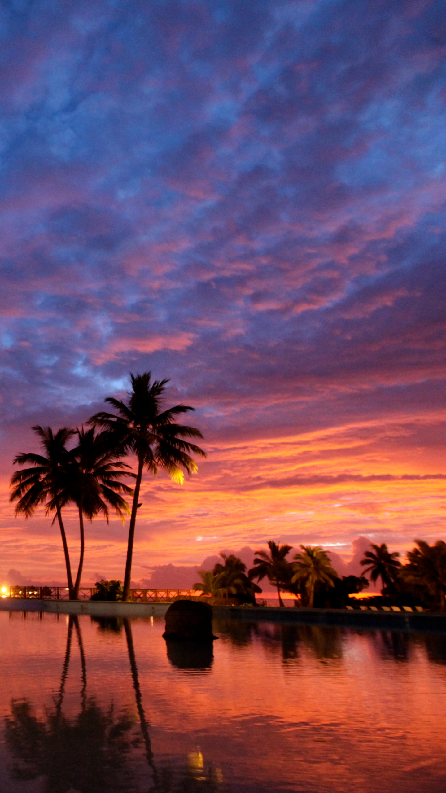 Download mobile wallpaper Sunset, Tropical, Resort, Man Made, Palm Tree for free.