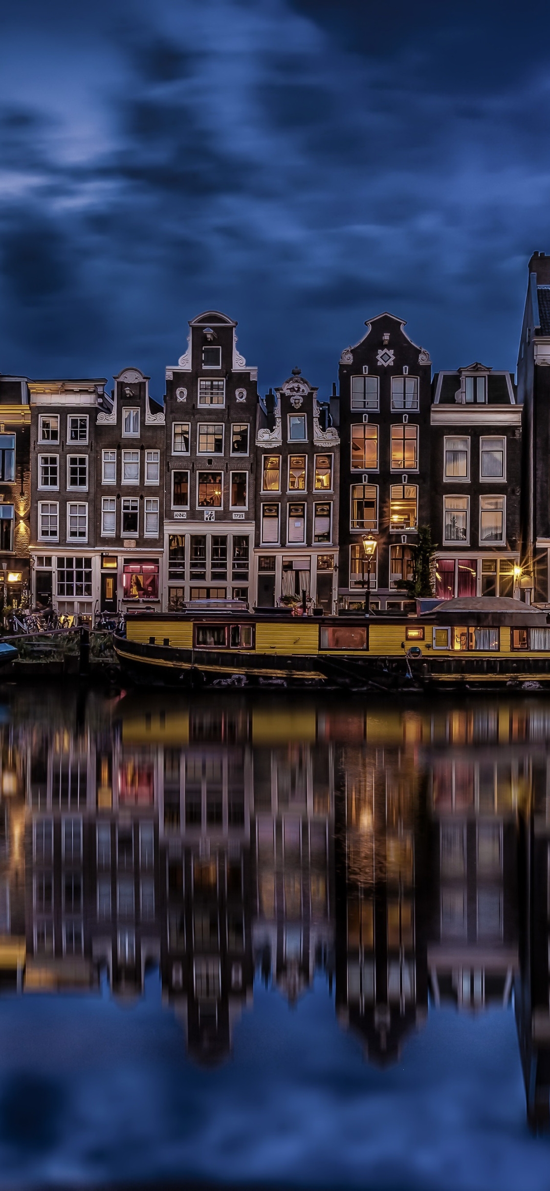 Download mobile wallpaper Cities, Night, Reflection, Light, House, Boat, Netherlands, Amsterdam, Man Made, Canal for free.