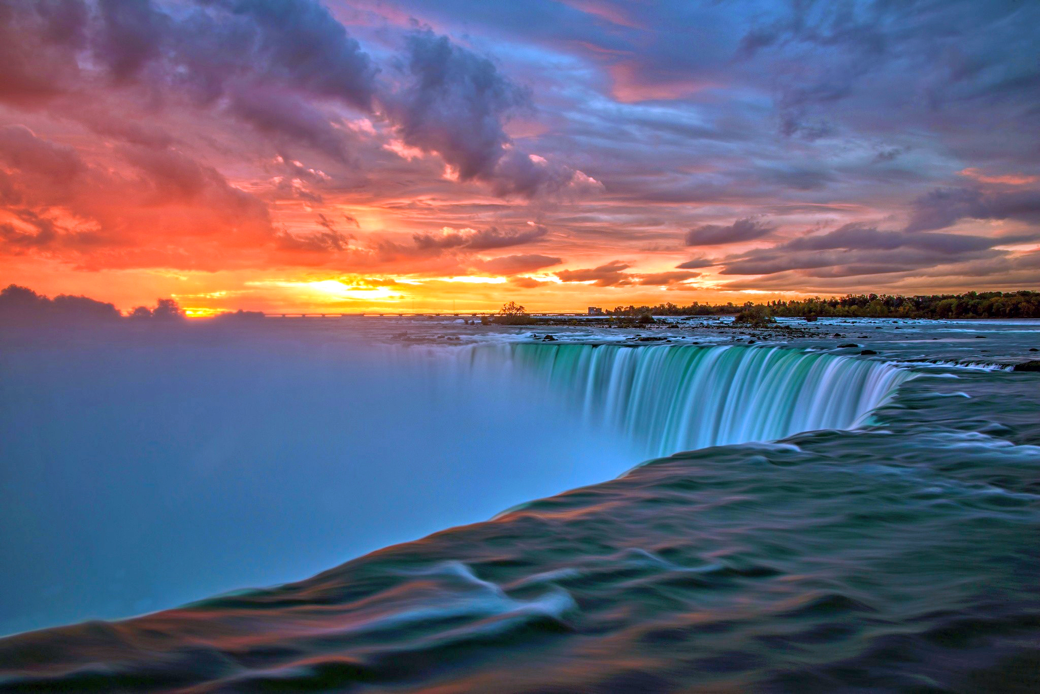 Download mobile wallpaper Sunset, Sky, Waterfalls, Horizon, Waterfall, Earth, Cloud for free.