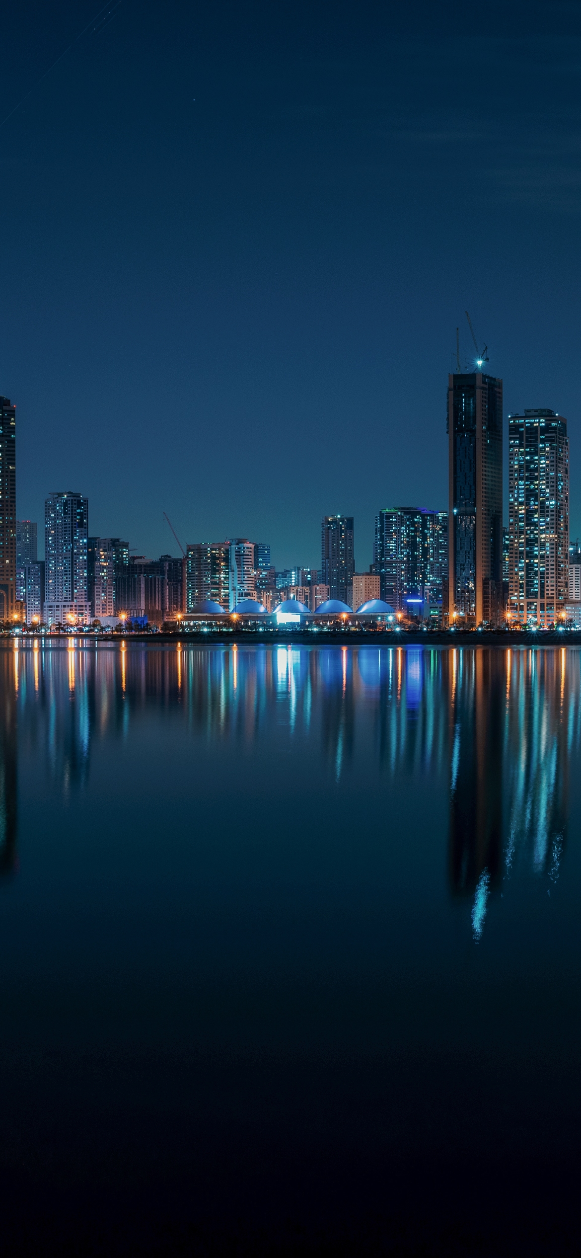 Download mobile wallpaper Cities, Water, Night, City, Skyscraper, Building, Reflection, United Arab Emirates, Man Made, Sharjah for free.