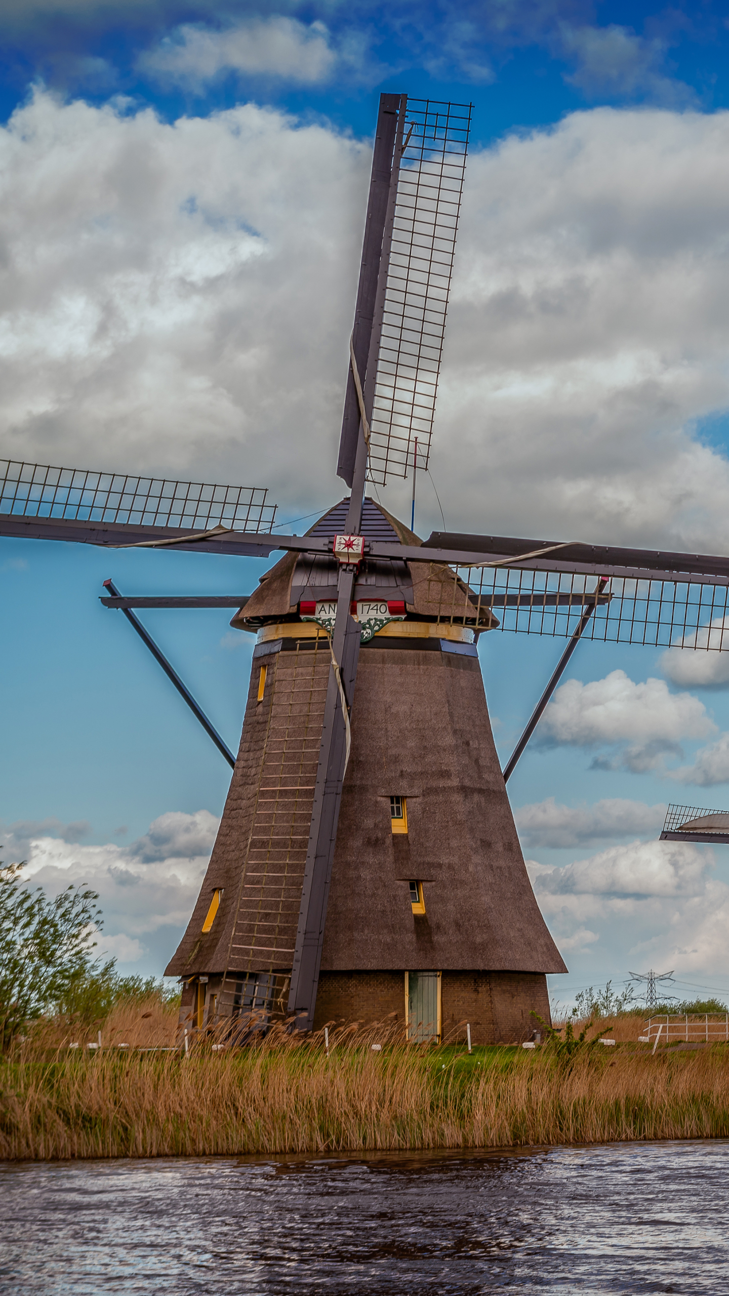 Download mobile wallpaper Sky, Building, Cloud, Netherlands, Windmill, Man Made for free.