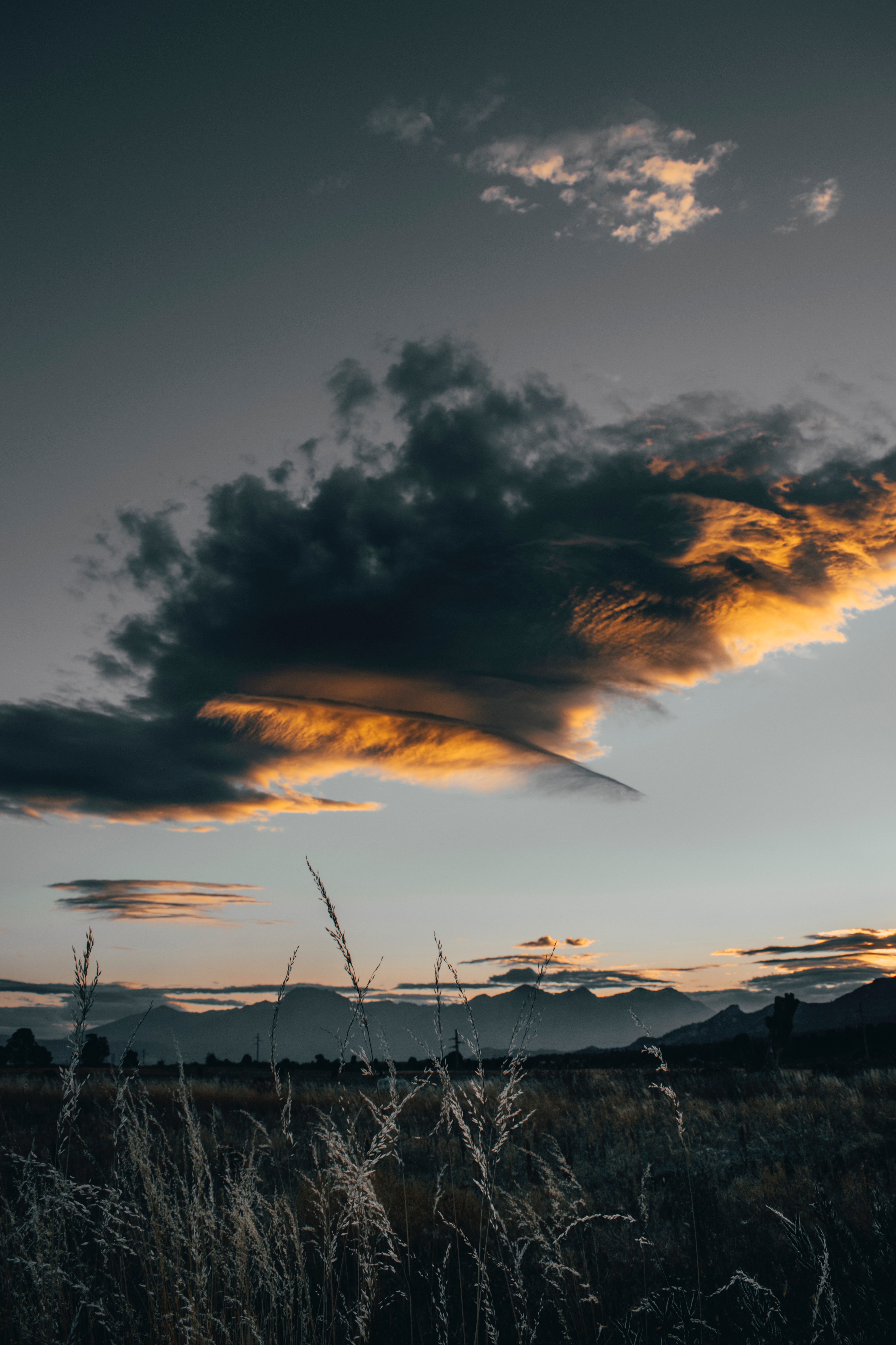 Download mobile wallpaper Clouds, Grass, Field, Dusk, Sunset, Nature, Twilight for free.
