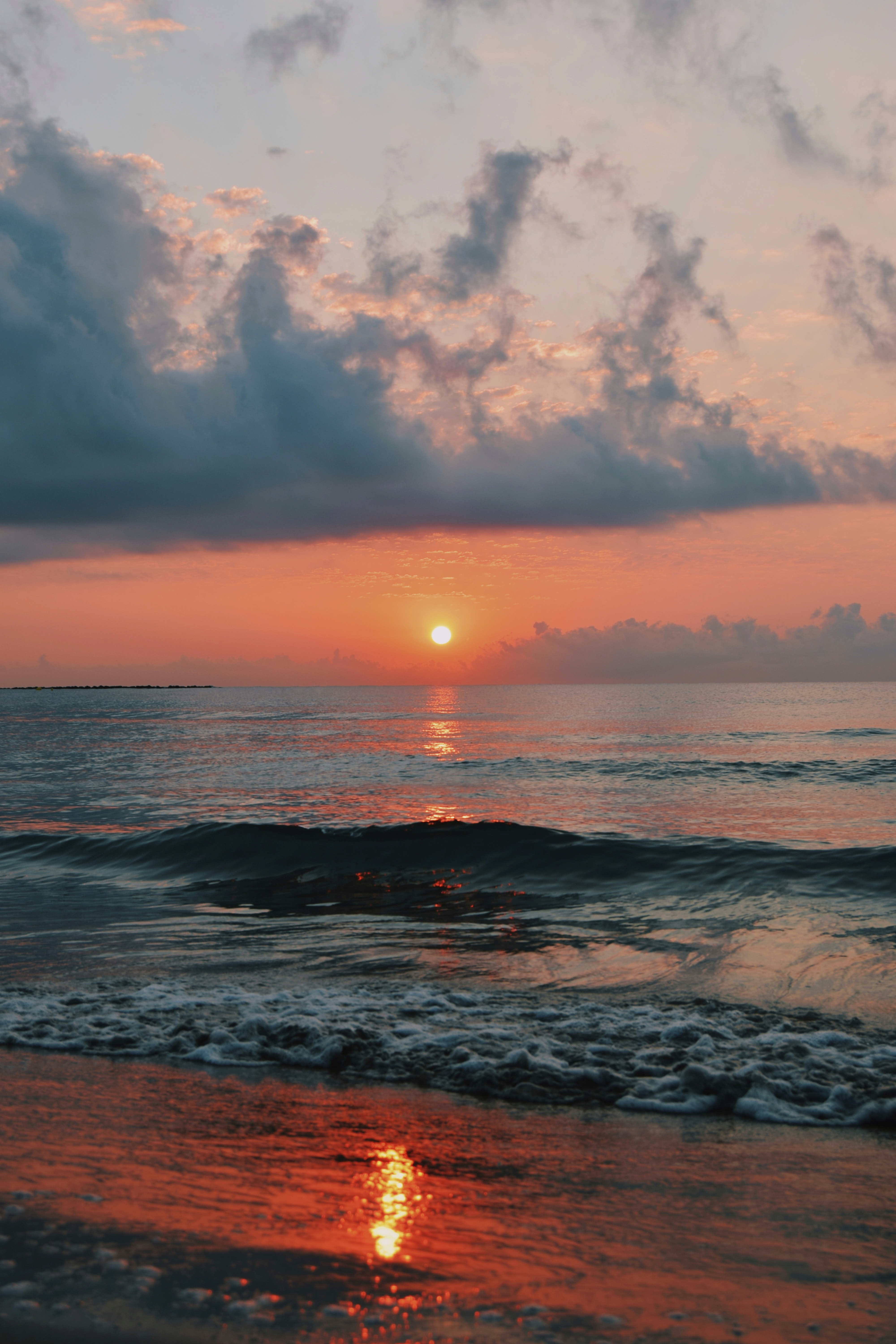 Download mobile wallpaper Glare, Nature, Water, Waves, Horizon, Sunset, Sun for free.