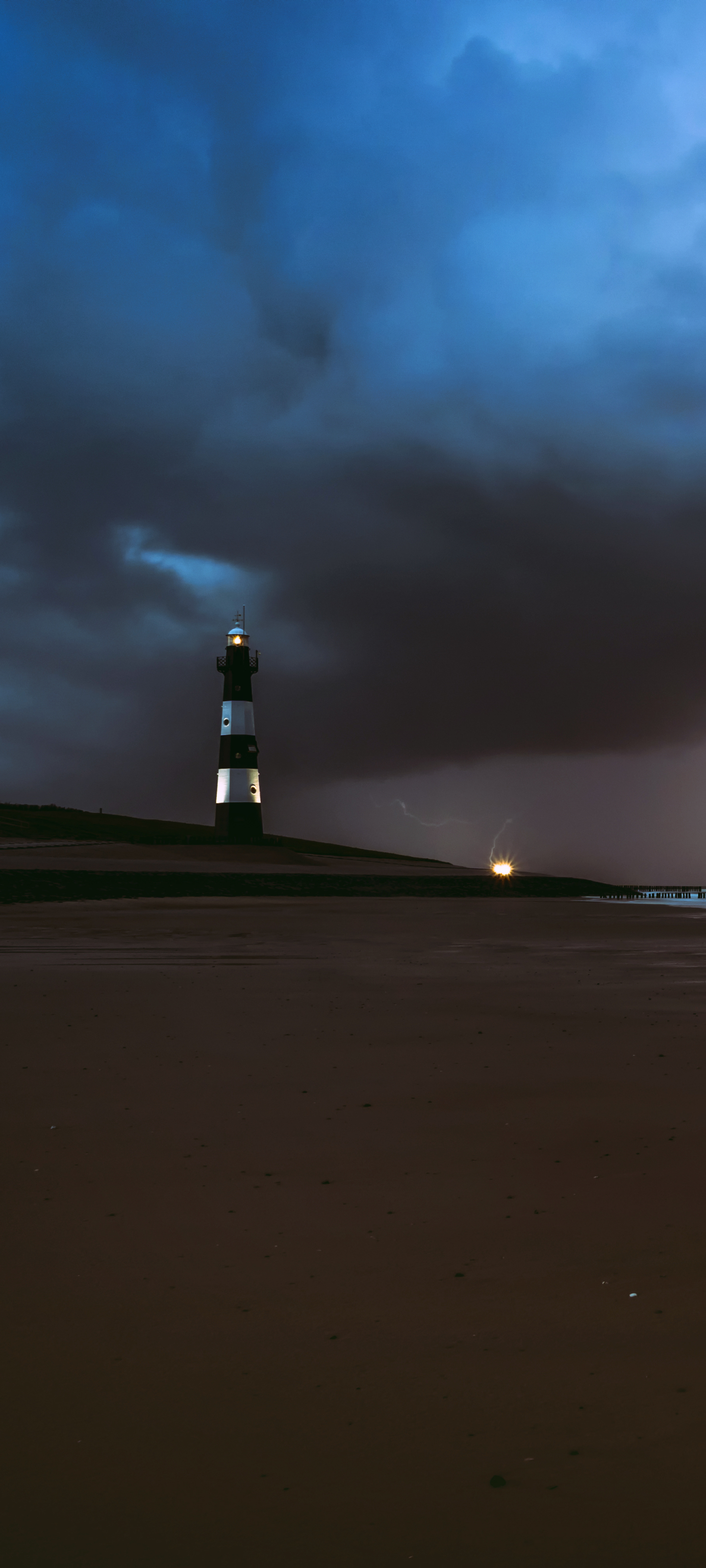 Download mobile wallpaper Night, Beach, Sand, Lighthouse, Man Made for free.