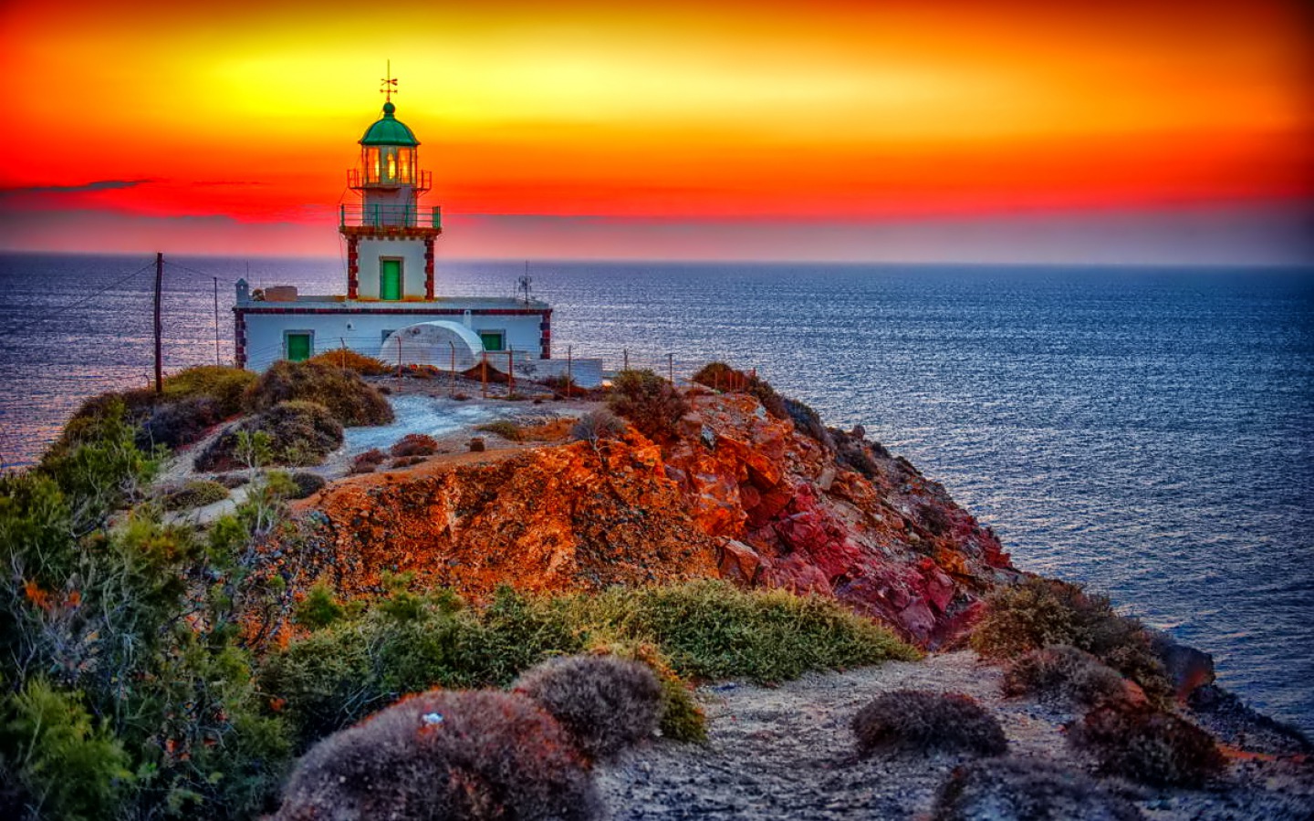 Download mobile wallpaper Sunset, Sky, Horizon, Ocean, Lighthouse, Man Made, Orange (Color) for free.