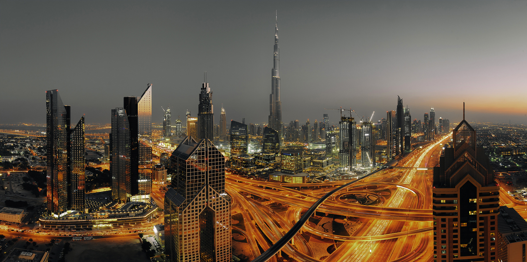 Download mobile wallpaper Cities, Night, City, Skyscraper, Building, Dubai, Cityscape, United Arab Emirates, Highway, Man Made for free.