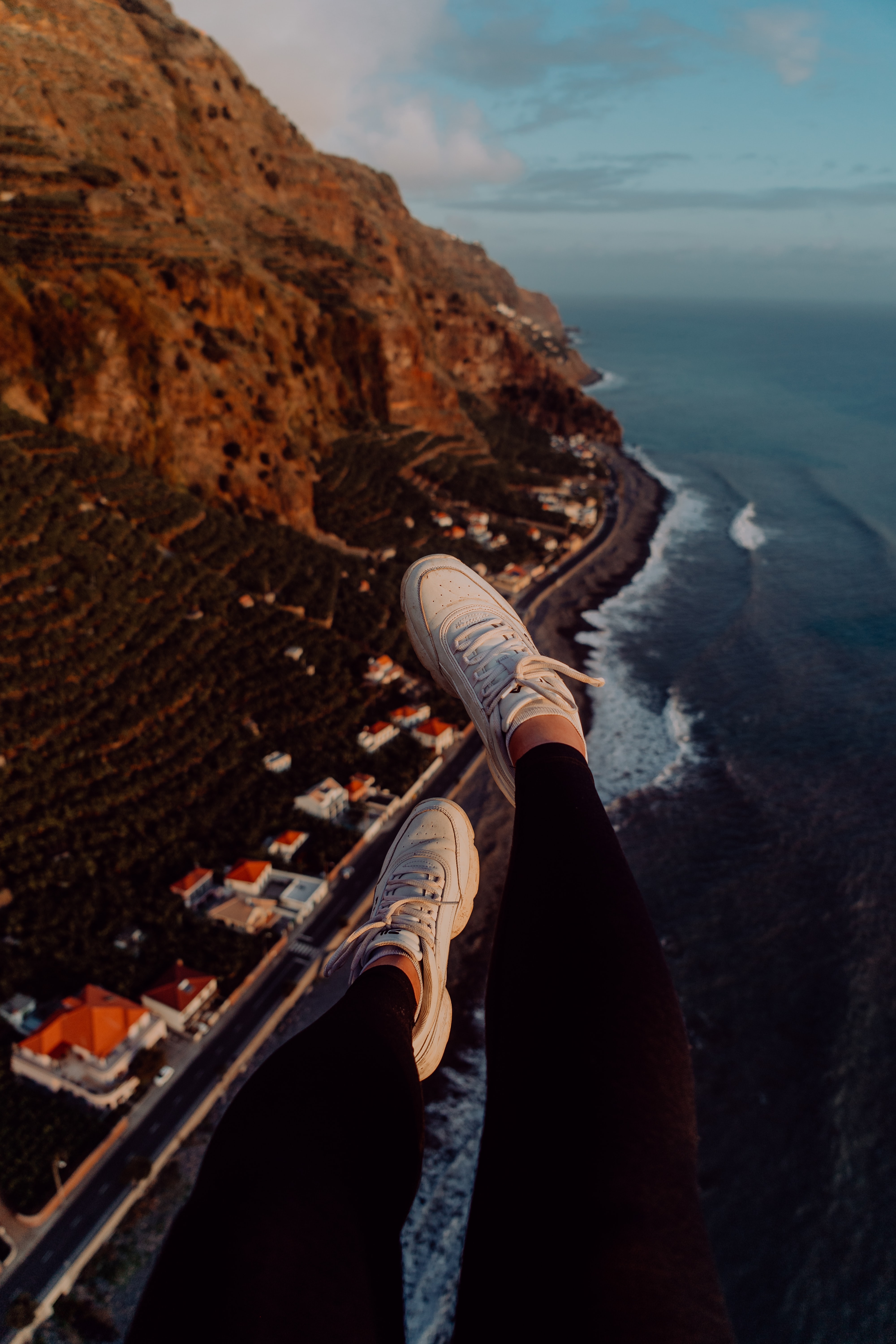 Download mobile wallpaper Coast, Miscellanea, City, View From Above, Legs, Miscellaneous, Sneakers, Mountains for free.