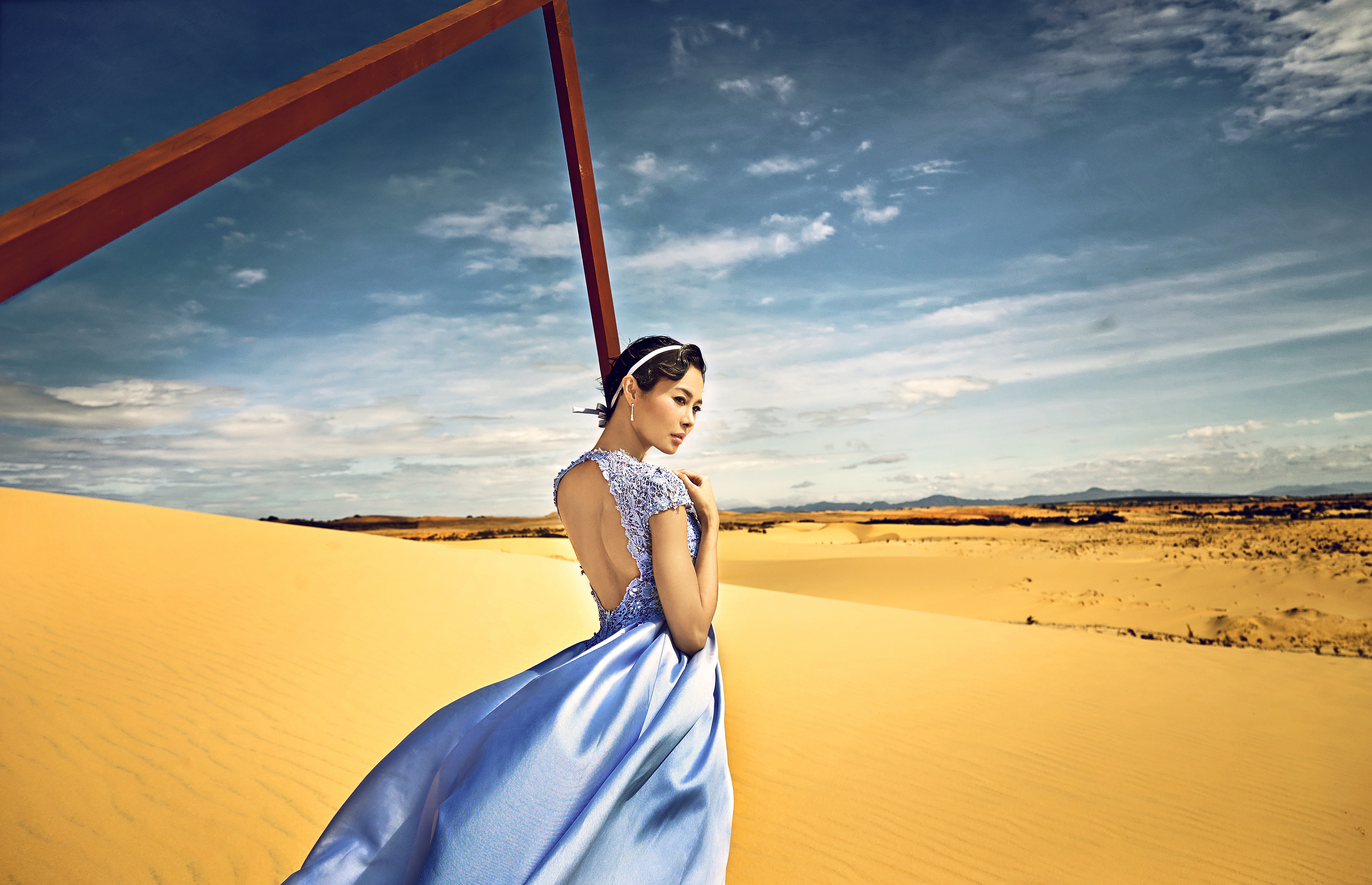 Download mobile wallpaper Sand, Desert, Horizon, Brunette, Model, Women, Asian, Blue Dress for free.