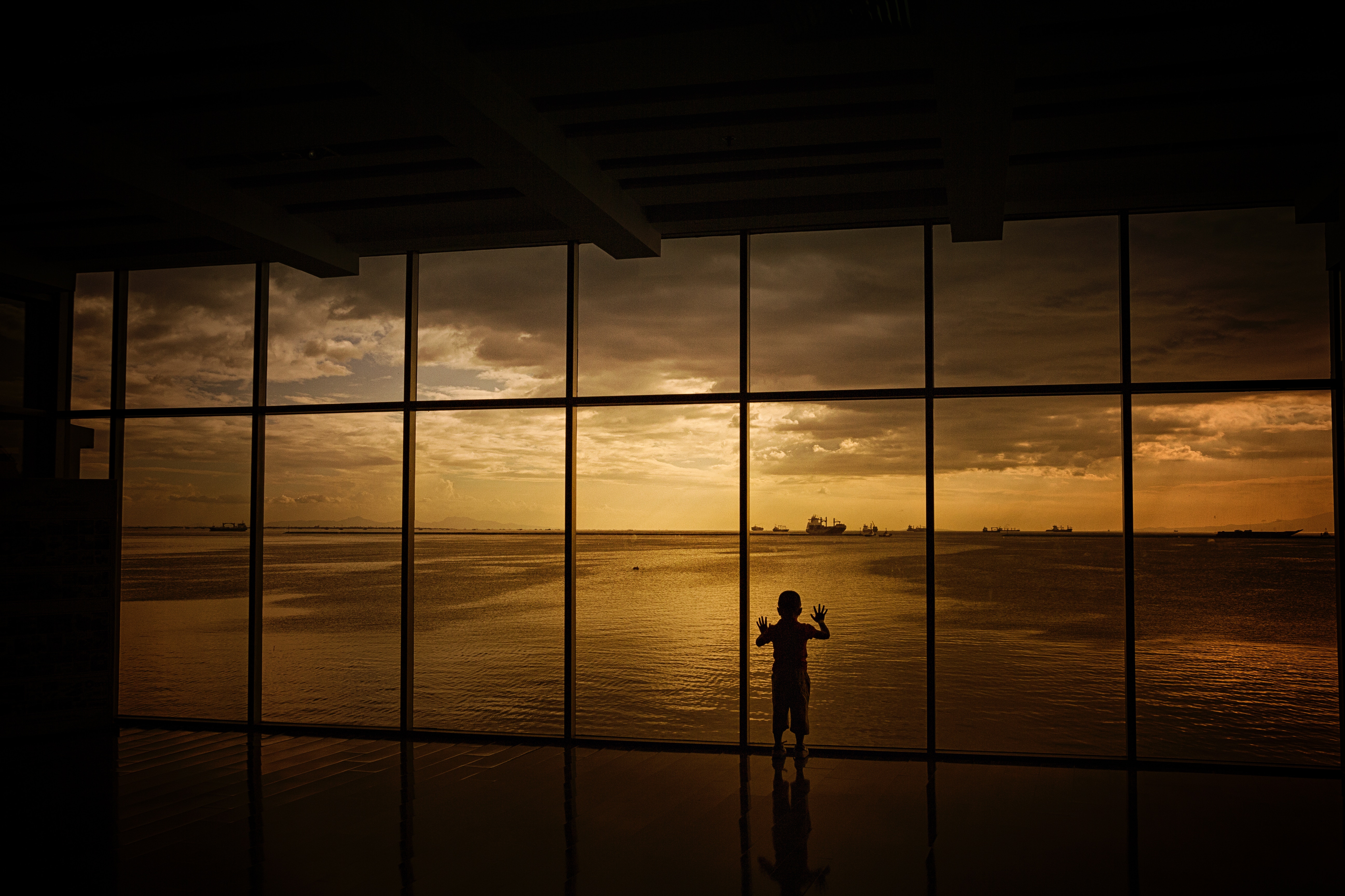 Download mobile wallpaper Clouds, Window, Sunset, Sea, Child, Silhouette, Dark for free.