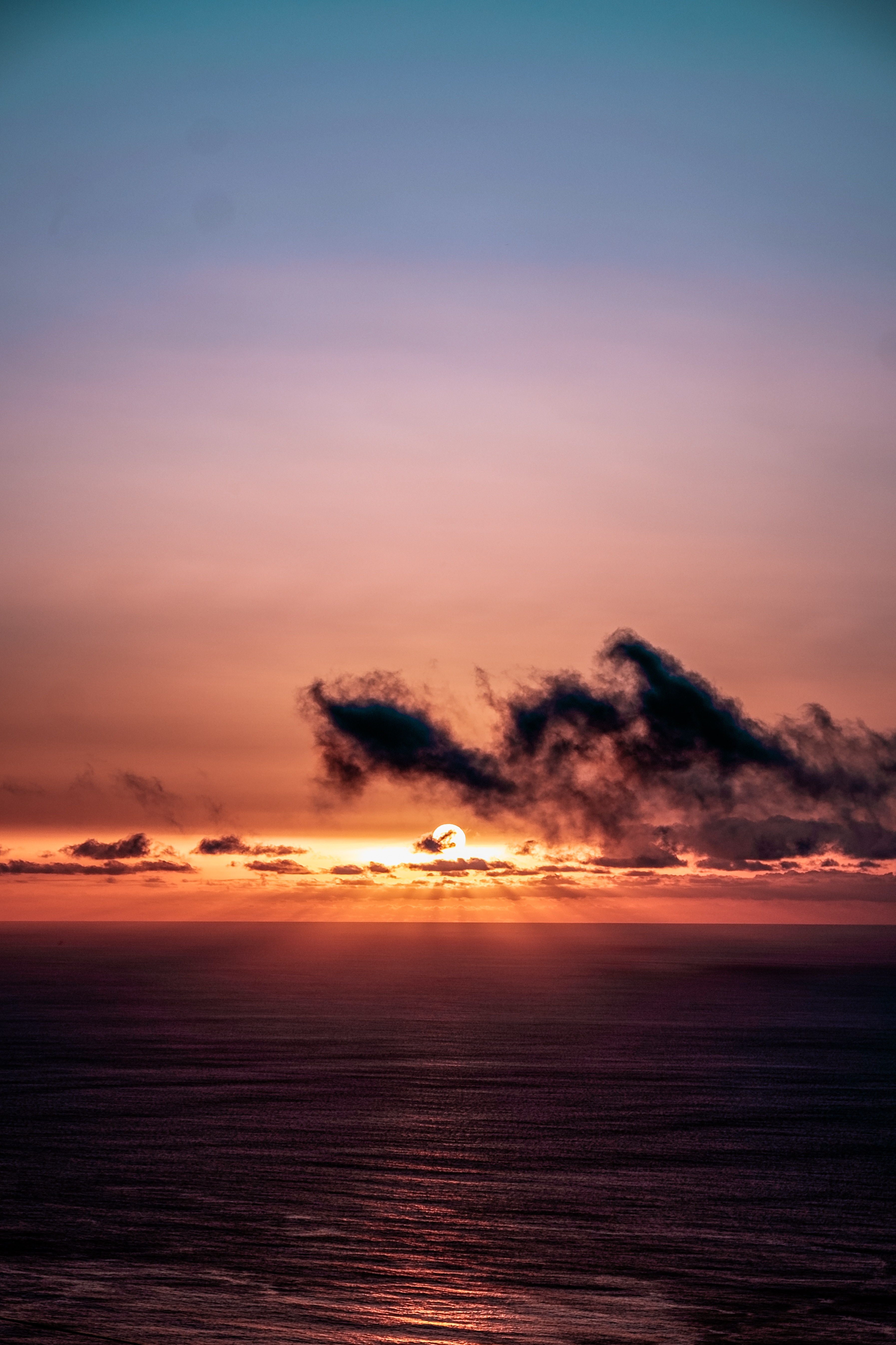 Download mobile wallpaper Clouds, Sky, Horizon, Nature, Sunset, Sea, Sun, Dark for free.