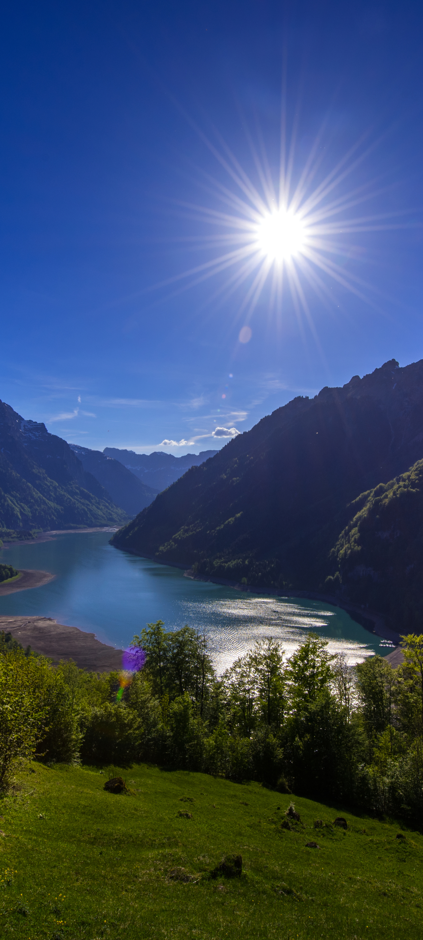 Скачать картинку Пейзаж, Солнце, Озеро, Швейцария, Земля/природа в телефон бесплатно.