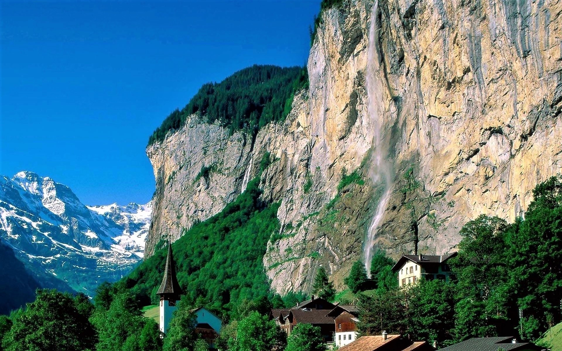 Download mobile wallpaper Mountain, Waterfall, Forest, House, Village, Switzerland, Church, Man Made for free.
