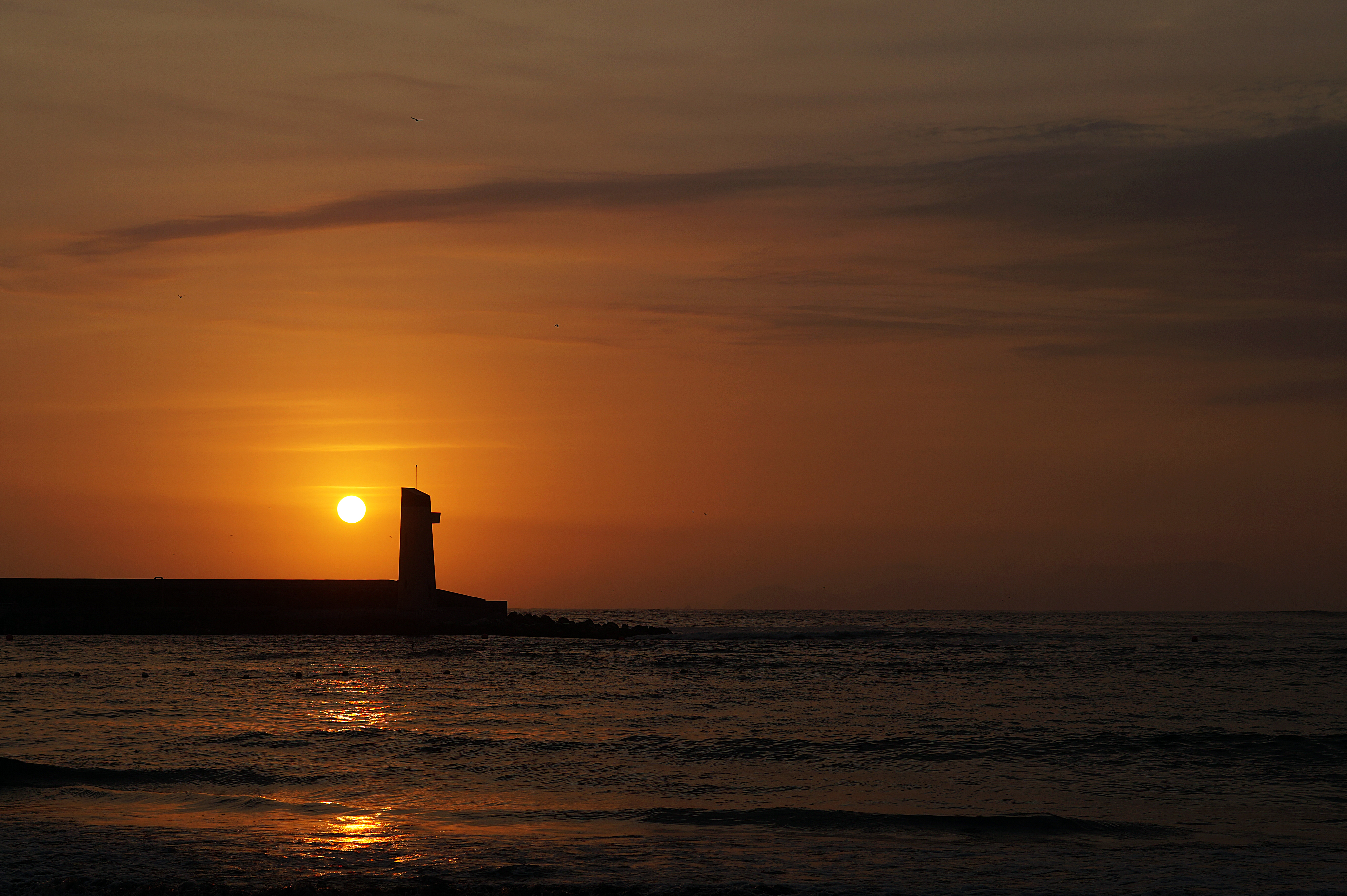 Download mobile wallpaper Horizon, Sun, Sea, Nature, Sunset, Lighthouse for free.