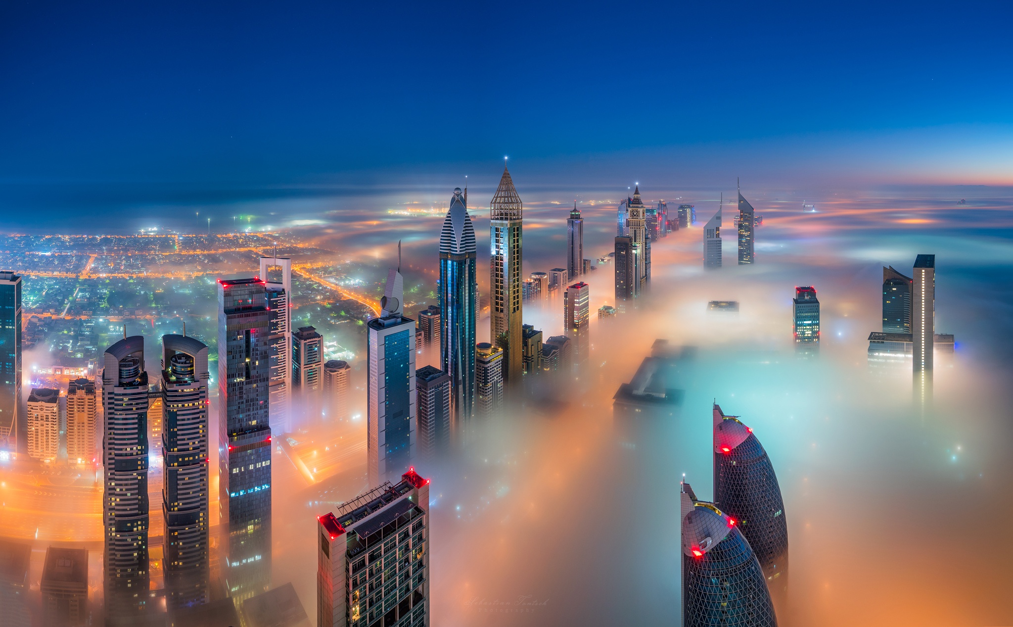 Free download wallpaper Cities, Sky, Night, City, Skyscraper, Building, Light, Fog, Dubai, United Arab Emirates, Man Made on your PC desktop