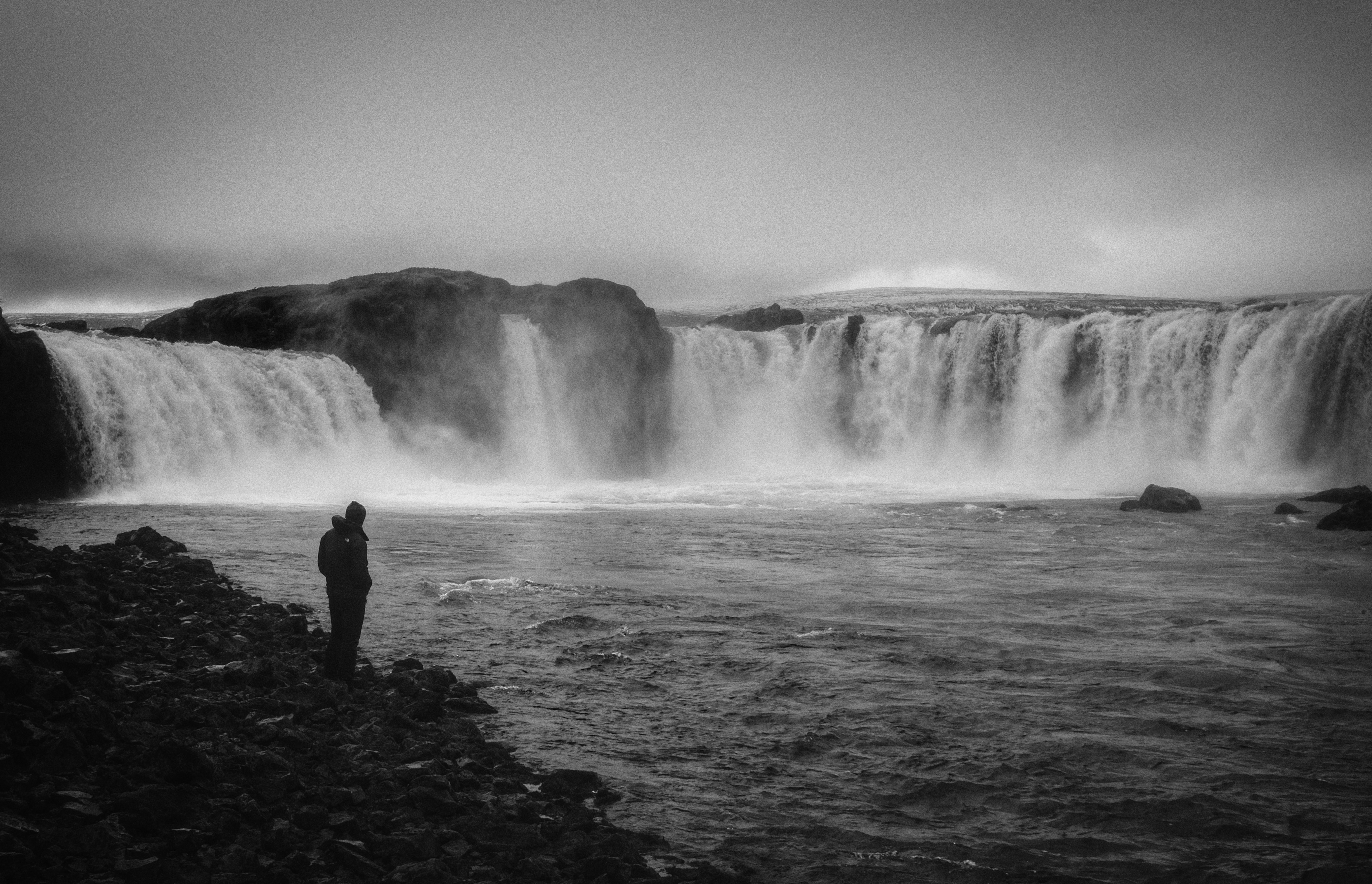Download mobile wallpaper Waterfall, Chb, Person, Miscellaneous, Bw, Miscellanea, Human, Nature, Loneliness for free.