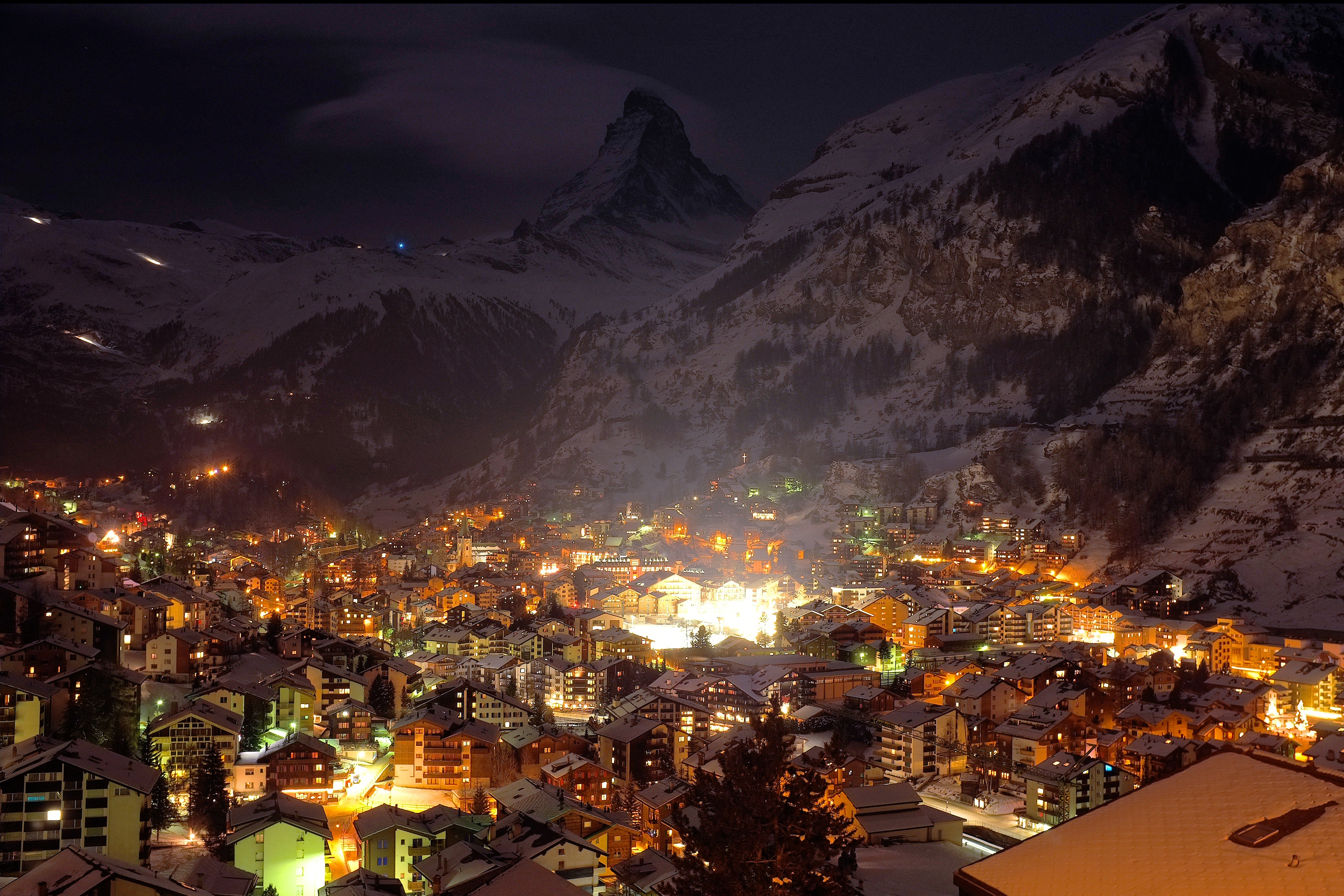Download mobile wallpaper Winter, Night, Snow, Mountain, Light, House, Alps, Village, Switzerland, Valley, Man Made for free.